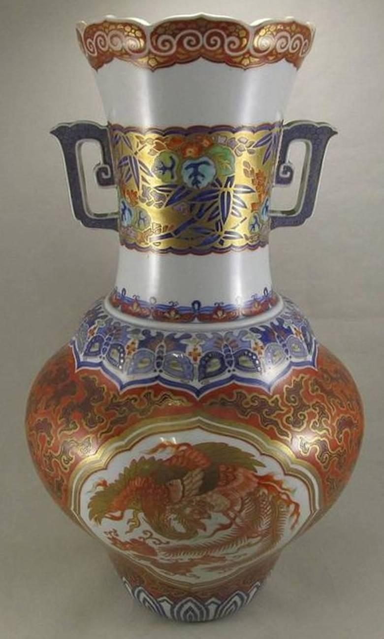 Exquisite early Meiji period Japanese pair of phoenix-tail gilded and hand-painted porcelain vases with two panels depicting very finely painted dragon in the clouds and phoenix ,on white background, surrounded by arabesque pattern on iron-red