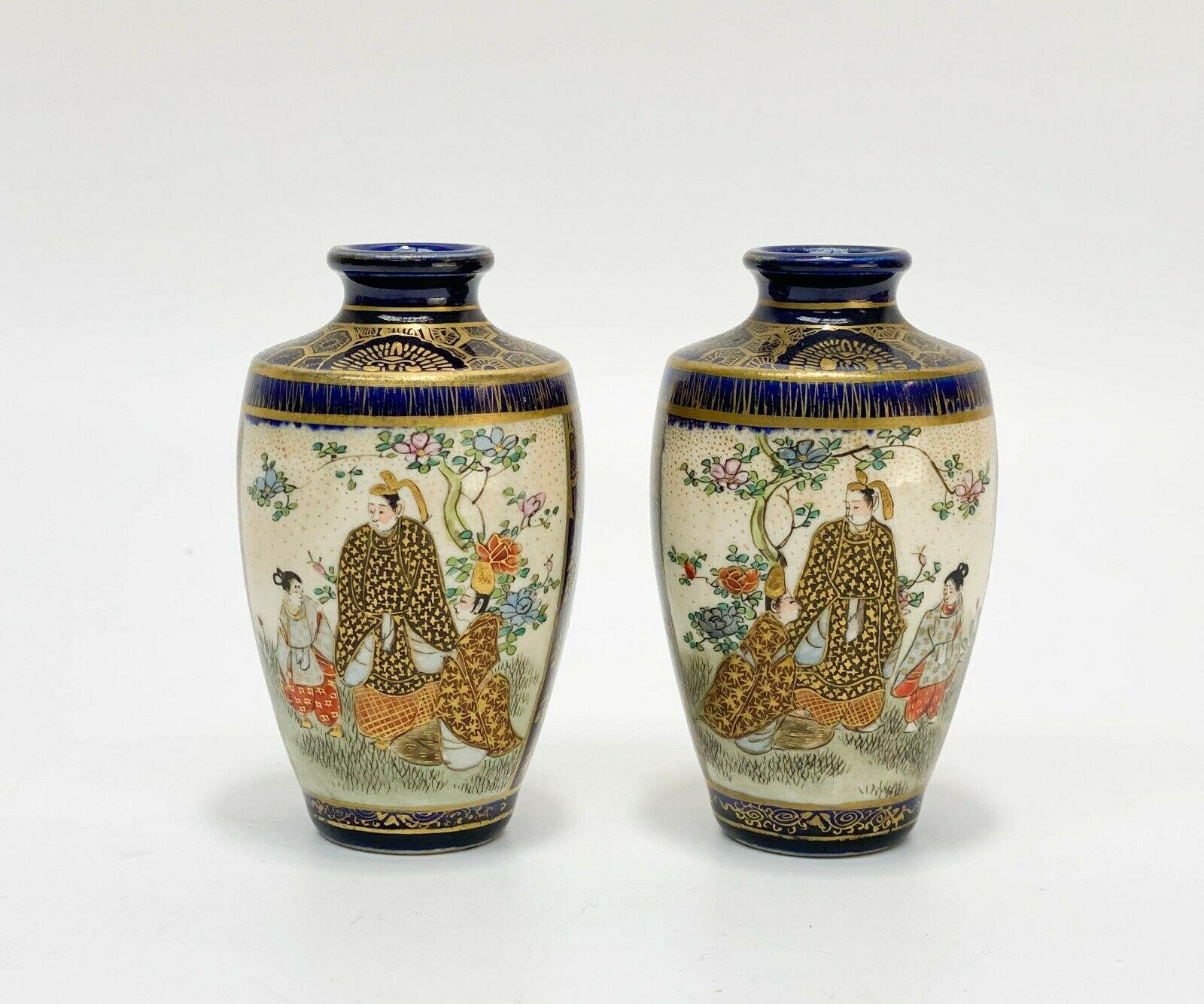 Pair of Japanese Satsuma hand painted porcelain miniature vases, Meiji Period

Cobalt blue ground with geometric and floral gilt decoration. Hand painted images of figures in traditional kimono in indoor and outdoor scenes with raised enamel