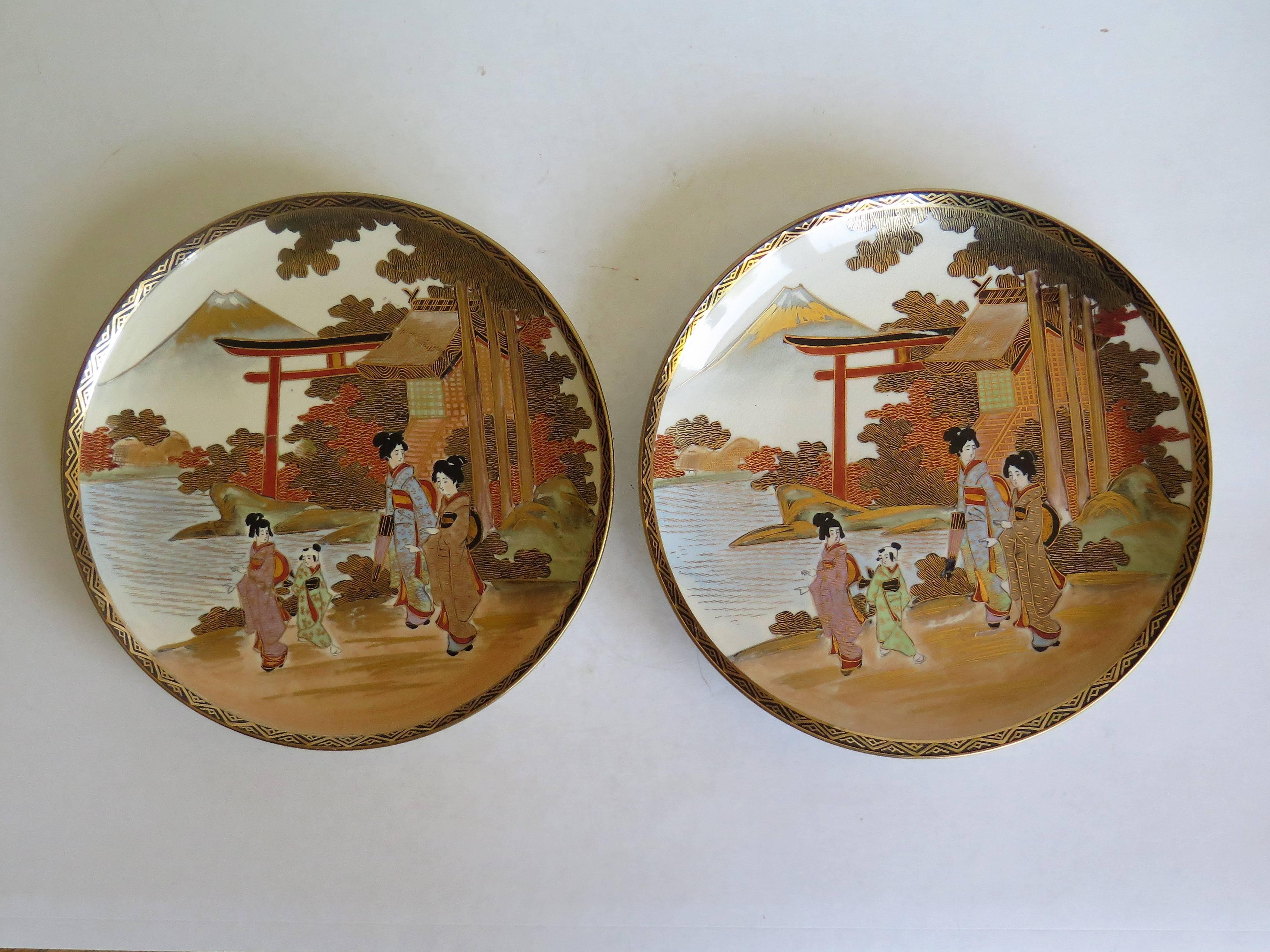 These are a good pair of Japanese earthenware plates with hand-painted and gilded Satsuma decoration which we date to the late Meiji period, circa 1900.

Each plate is circular, well hand decorated with a landscape scene depicting women wearing