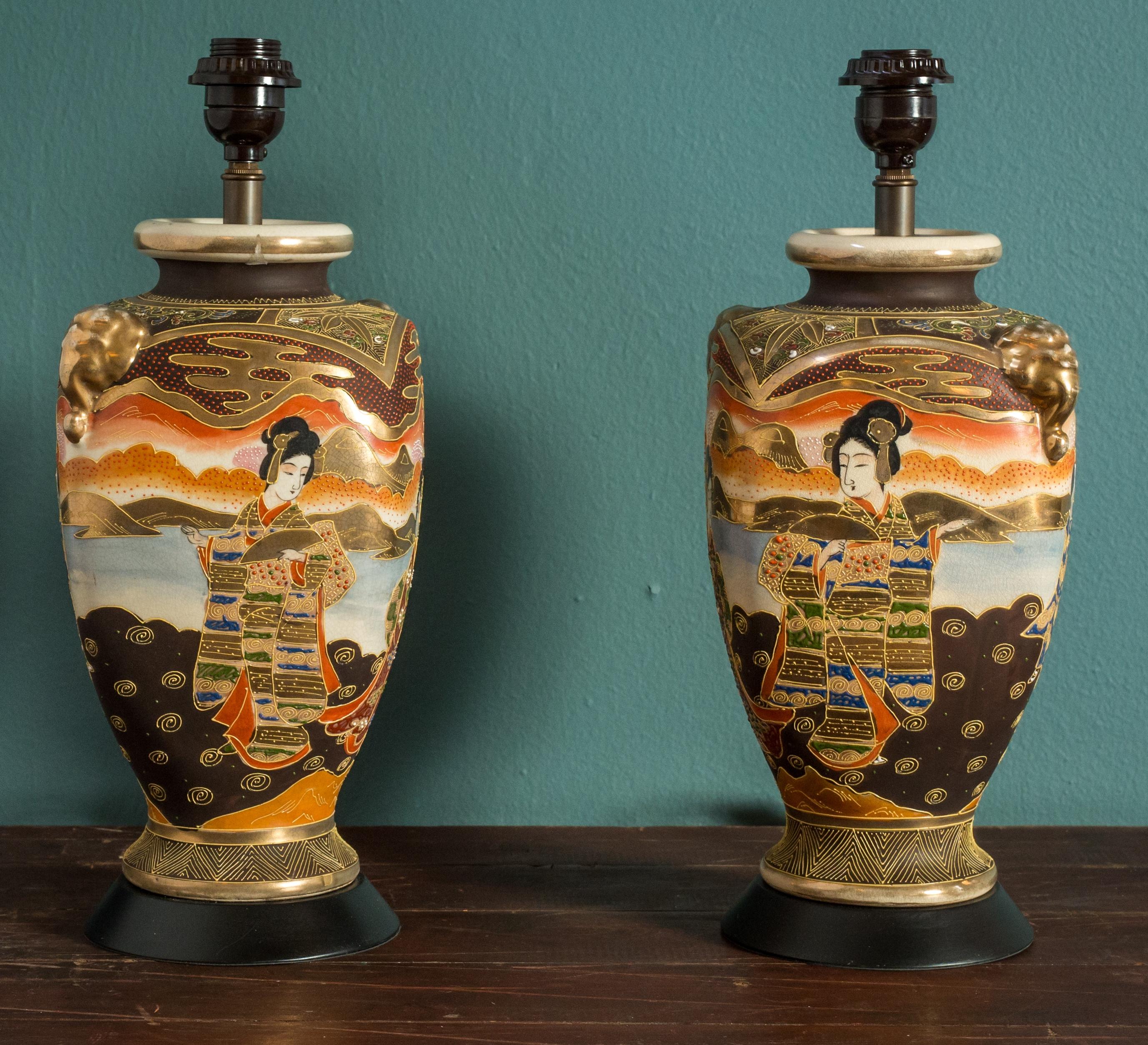 This beautiful pair of lamps has relief decoration with enameled, painted, and gilt design. The lamps have been wired with European sockets; however, we can change the sockets to a harp and saddle. Sold together as a pair for $3,100.