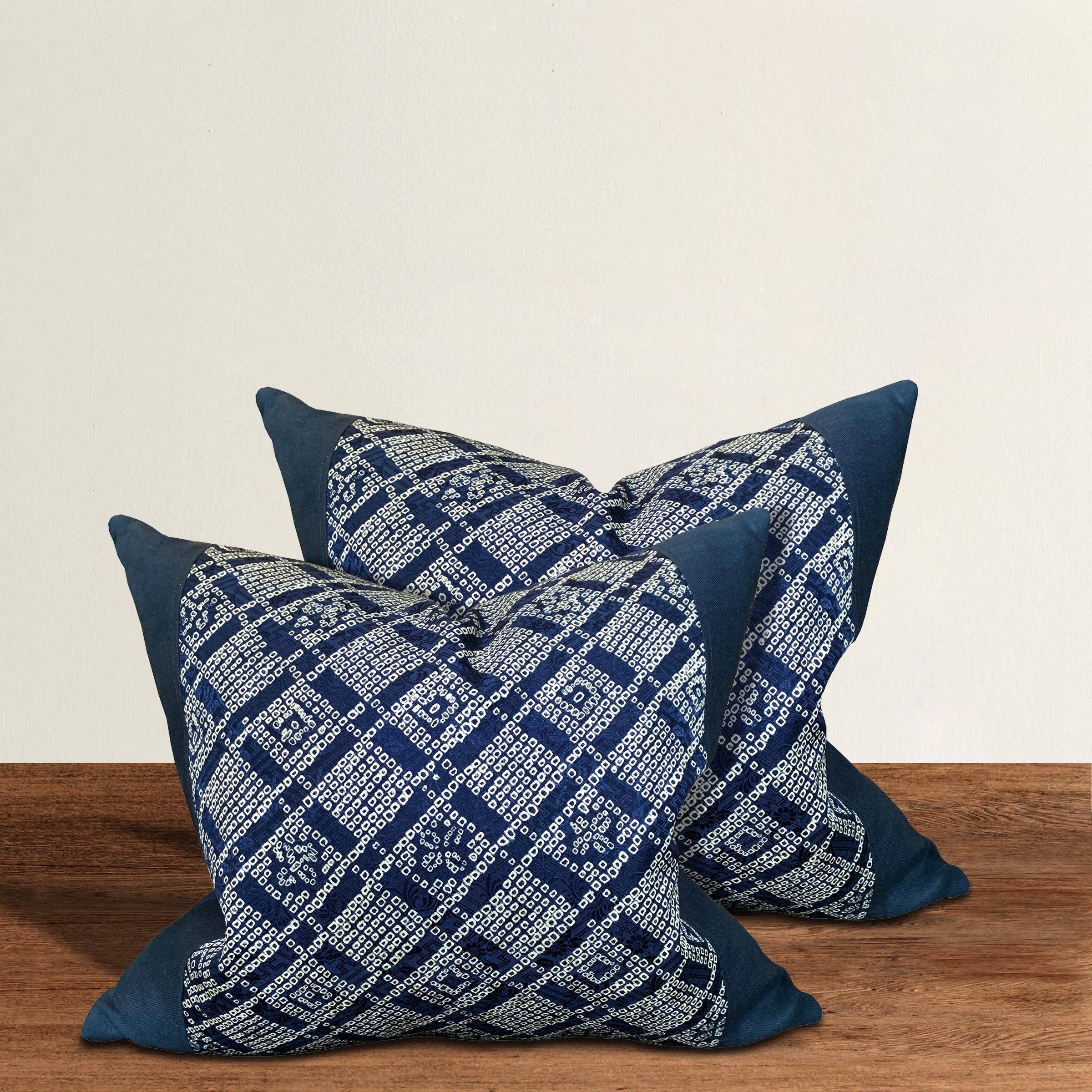 A pair of pillows made from vintage Japanese blue and white indigo shibori silk panels with an incredible geometric grid pattern with stylized flowers. Filled with down.