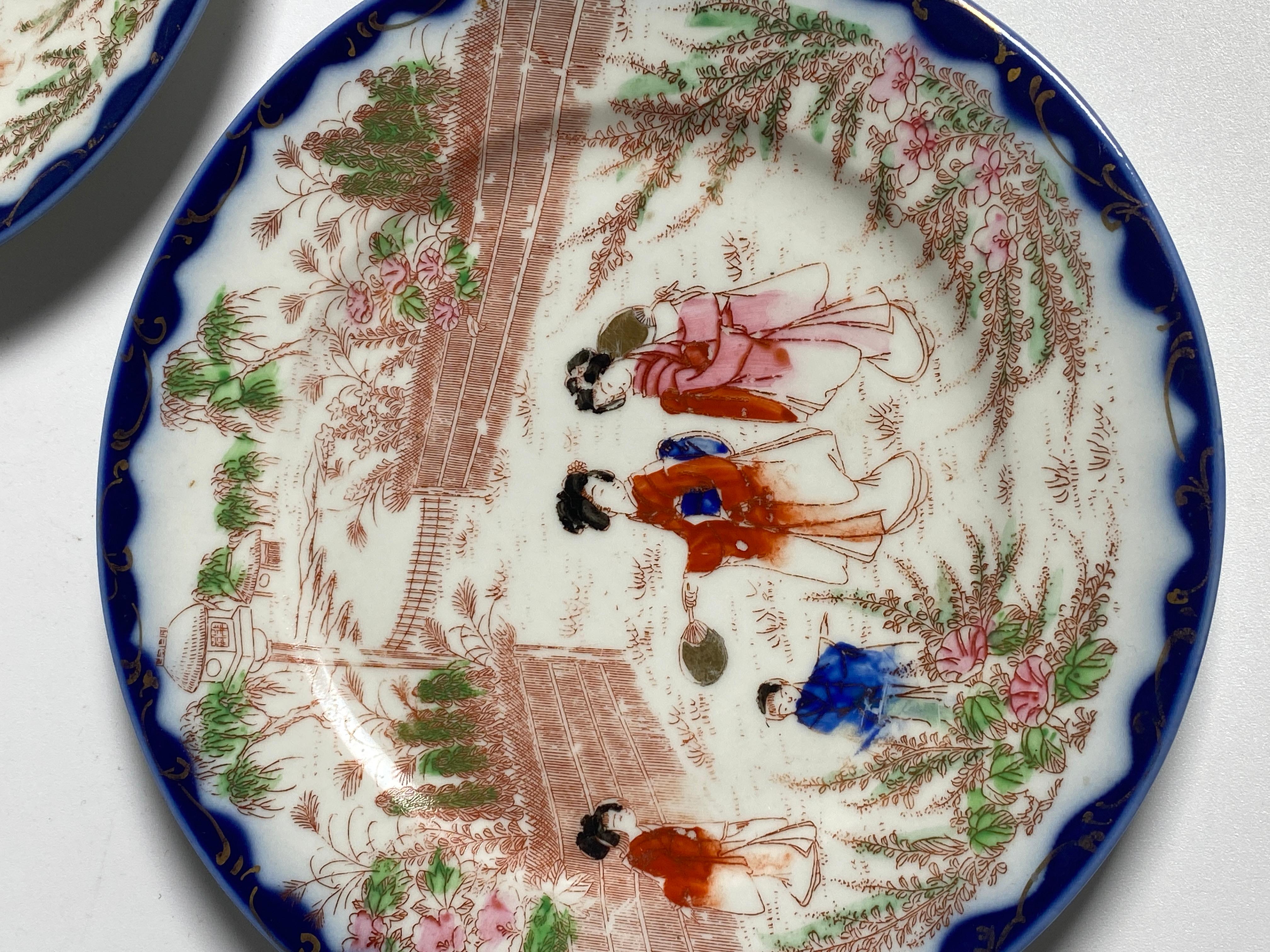 Pair of Japanese porcelain plates. The colors are blue, pink and green. They were made in Japan in the 19th century.
