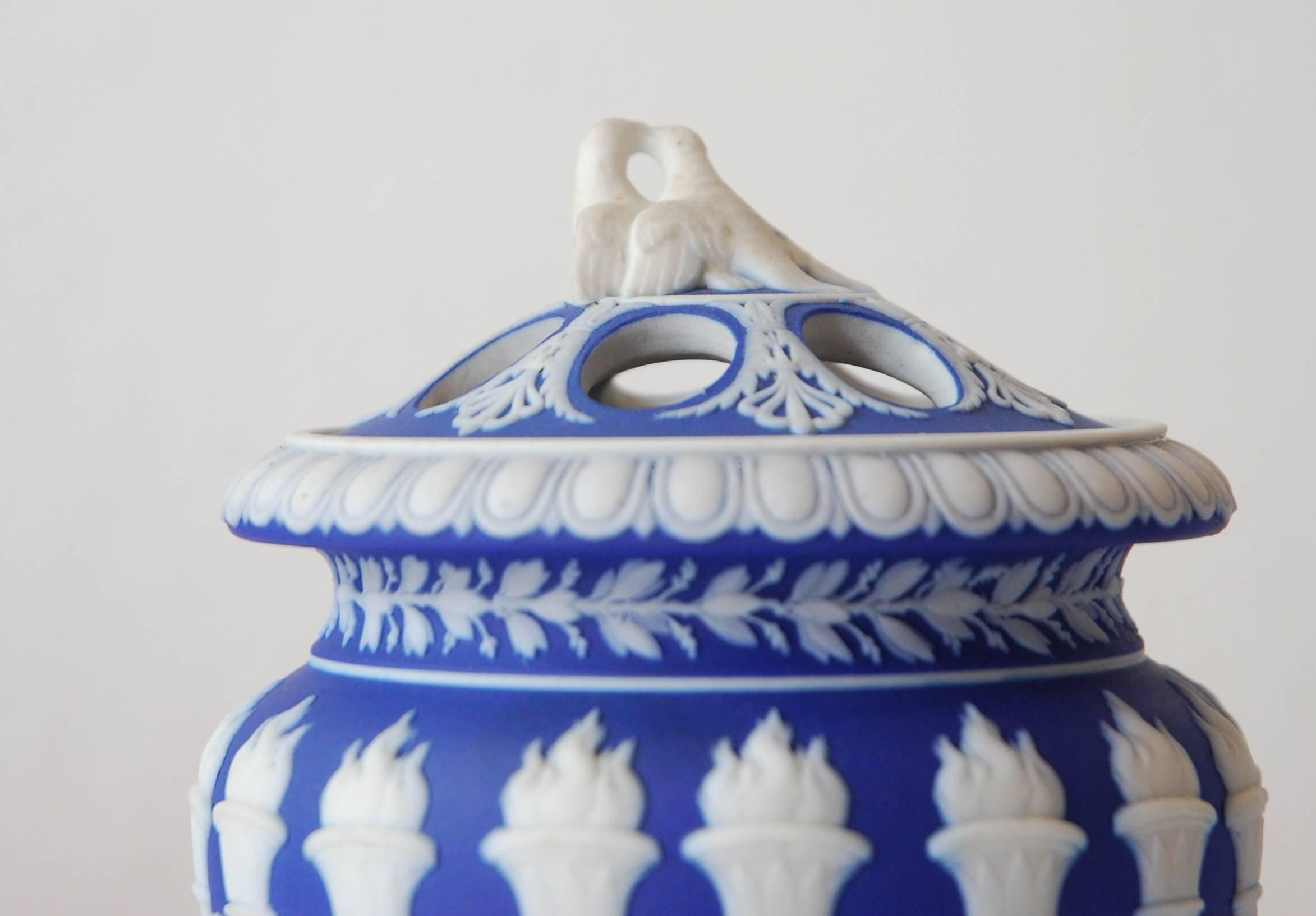 A rare pair of ‘Torch’ vases in cobalt jasper dip, complete with covers featuring a pair of love-birds.

The jasper dip over white stoneware, a typical combination during this period, gives a singular brilliant blue to the ground color.