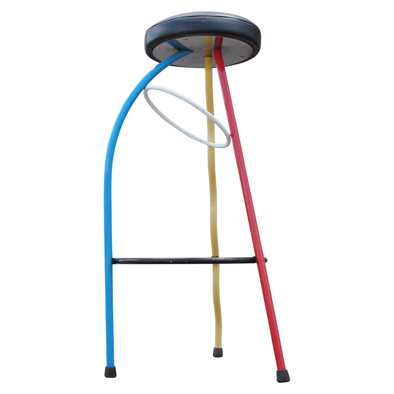 Quirky and fun pair of duplex bar stools by the famed Javier Mariscal. They have bright primary colored legs (red, yellow, blue) which contrast with the neutral accent colors (black, white).