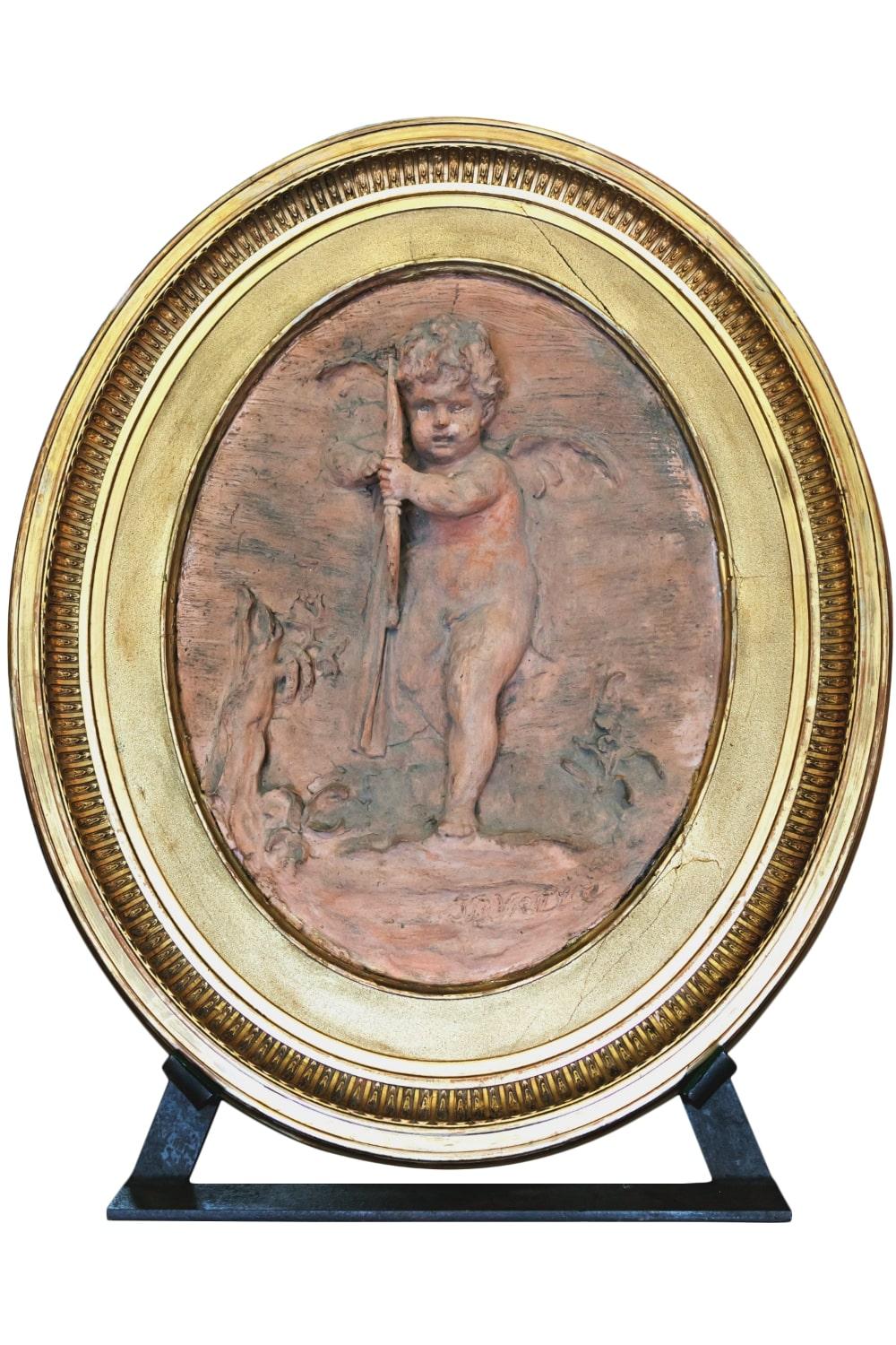 Fabulous pair of signed Jean Baptiste Vietty oval terracotta bas relief with iron stands, circa 1807. Each giltwood framed plaque features a cherub or putto with bow and quiver and is signed JB VIETTY on front. The reverse is signed JB VIETTY 1807