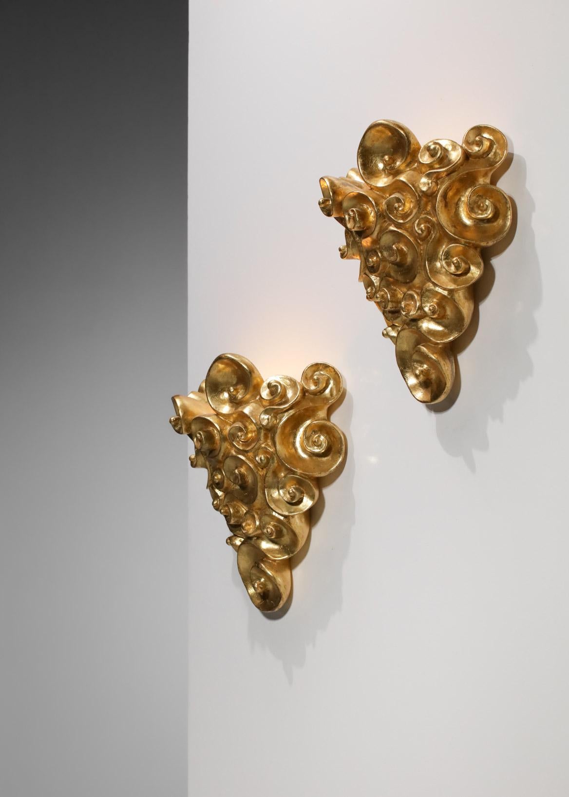 Imposing pair of French sconces from the 80's by the artist Jean Boggio for les Héritiers (signature on the back of the sconces). The structure is in plaster and covered with gold leaf.  Very nice vintage condition, note the traces of time and use