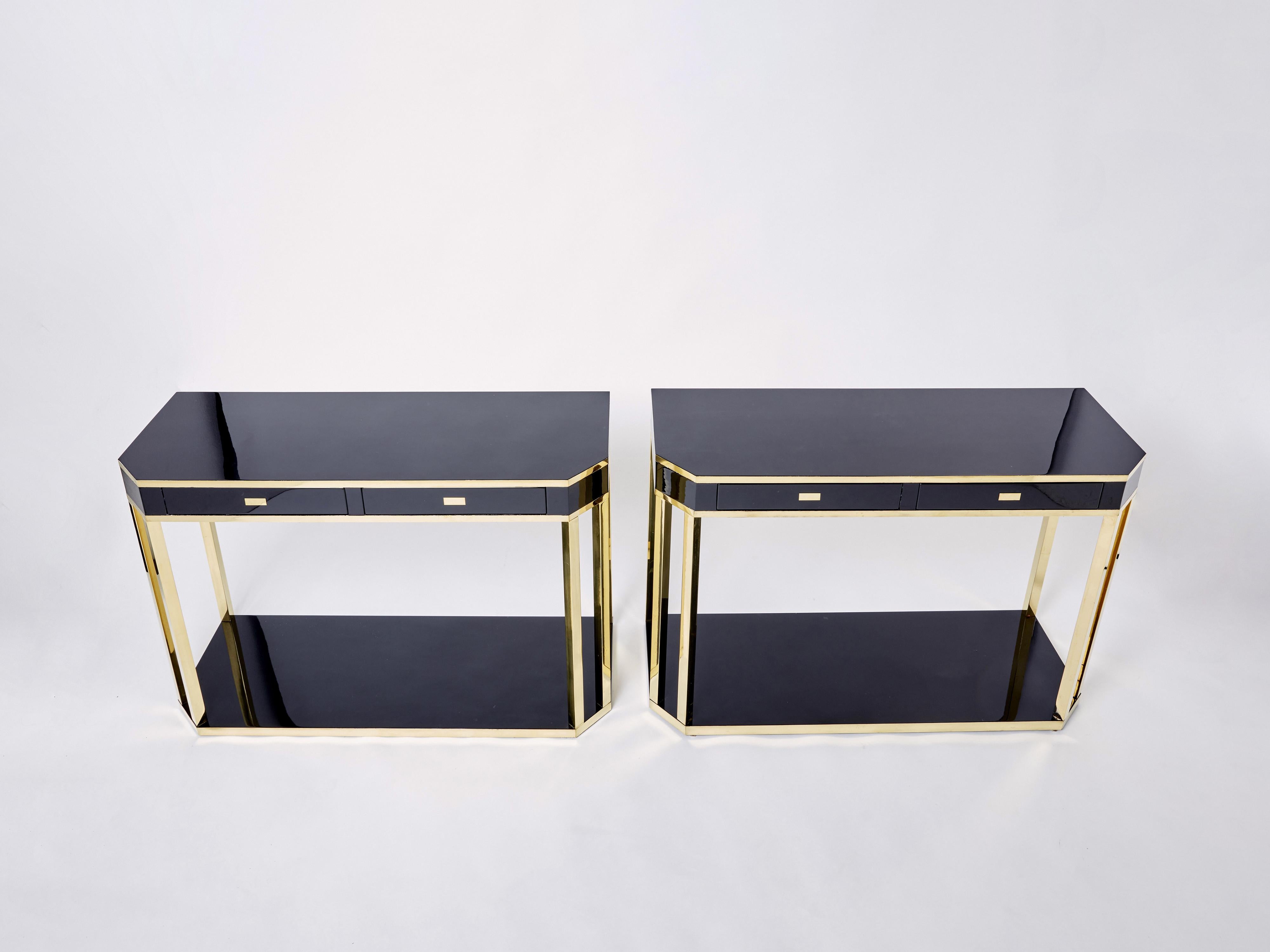 With a shining black lacquered top, and sharply geometric brass legs and details, this beautiful pair of console tables carries a stellar French mid-century aesthetic into the contemporary home. Its boxy yet sophisticated style is typical of both
