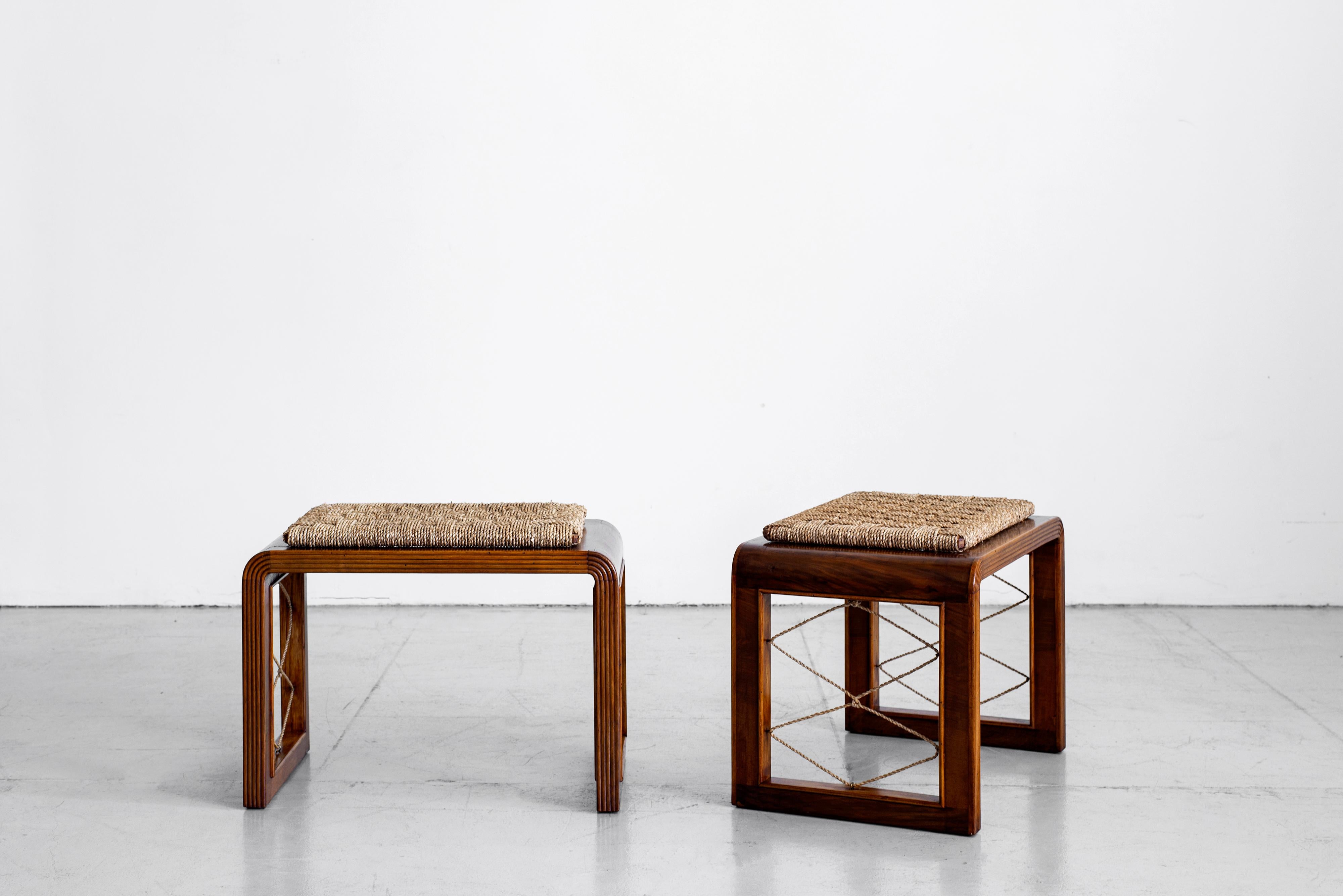 Fantastic pair of French bentwood stools in the style of Jean Royere. Curved wood frame with rushed seats and rope side 