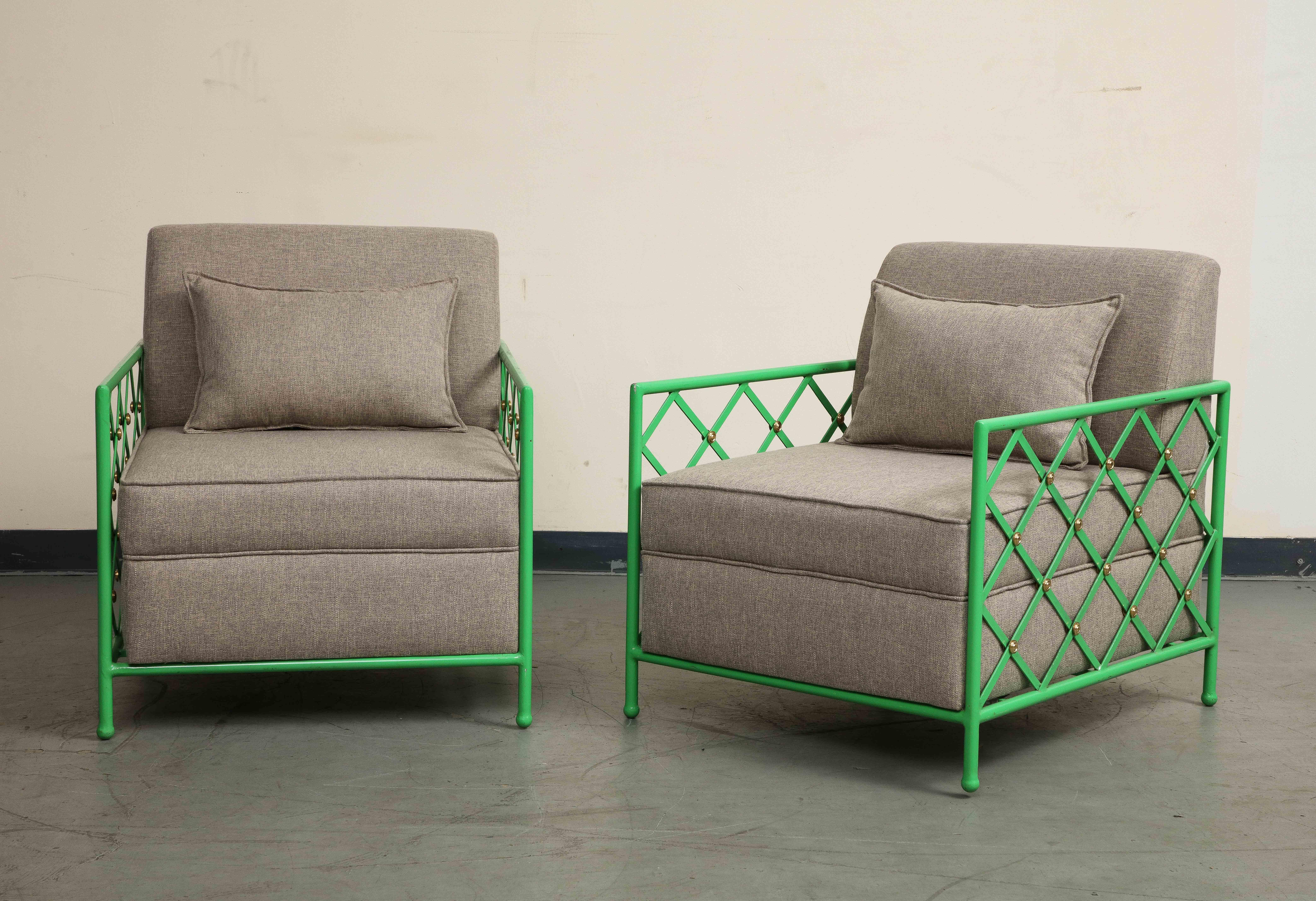 Pair of 20th century bright green enameled iron cube chairs. Mid-Century Modern style. Cross hatch pattern made of flat metal pieces on the back and sides with gilt fasteners/accents. Neutral / gray upholstered cushions with accent pillows in good