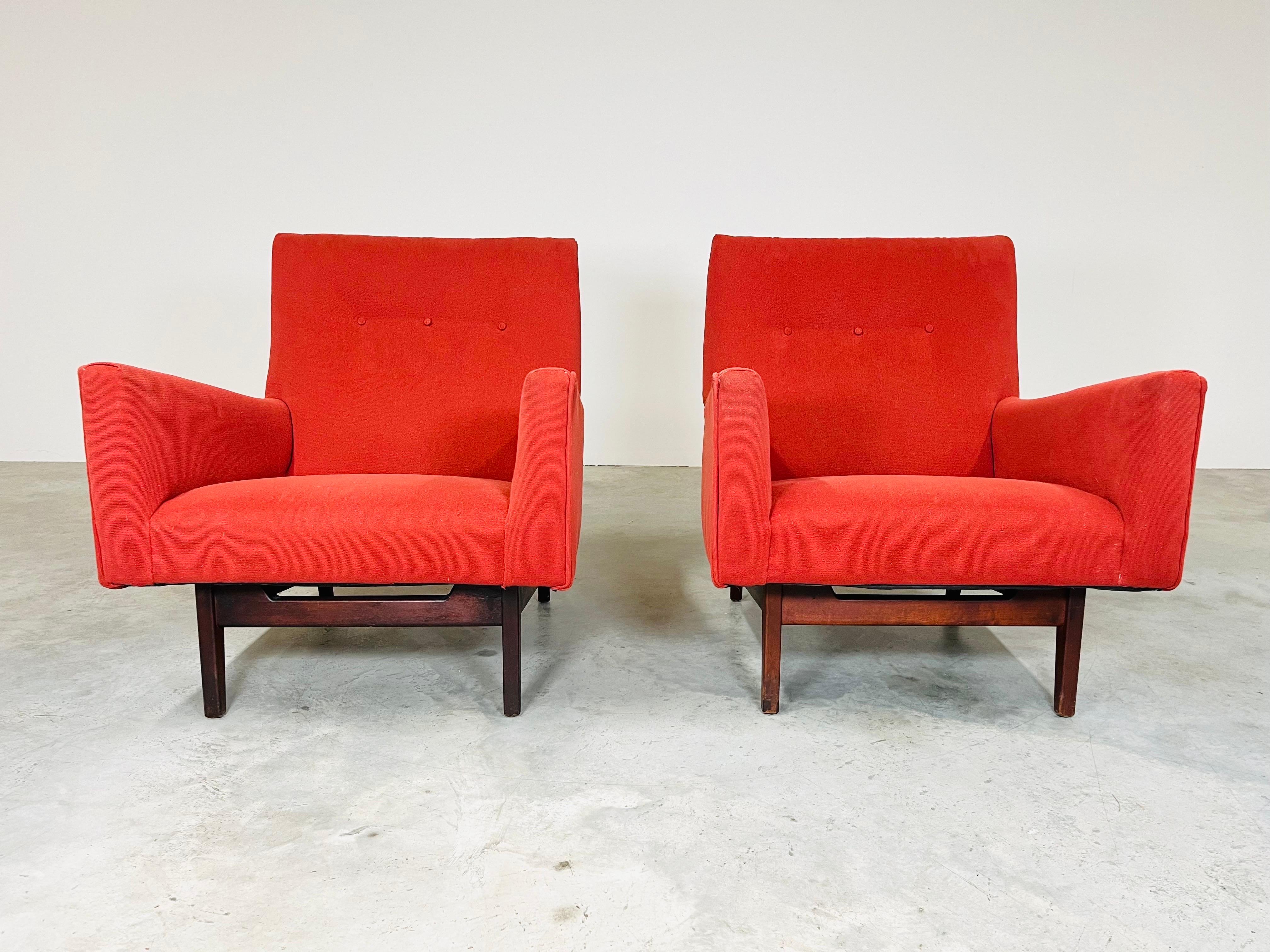 An early pair of Jens Risom Easy Armchairs having walnut bases under a flawlessly designed seat with armrests. Extremely comfortable having stunning lines. North America circa 1960. 
In fabulous vintage condition with some ware to the original