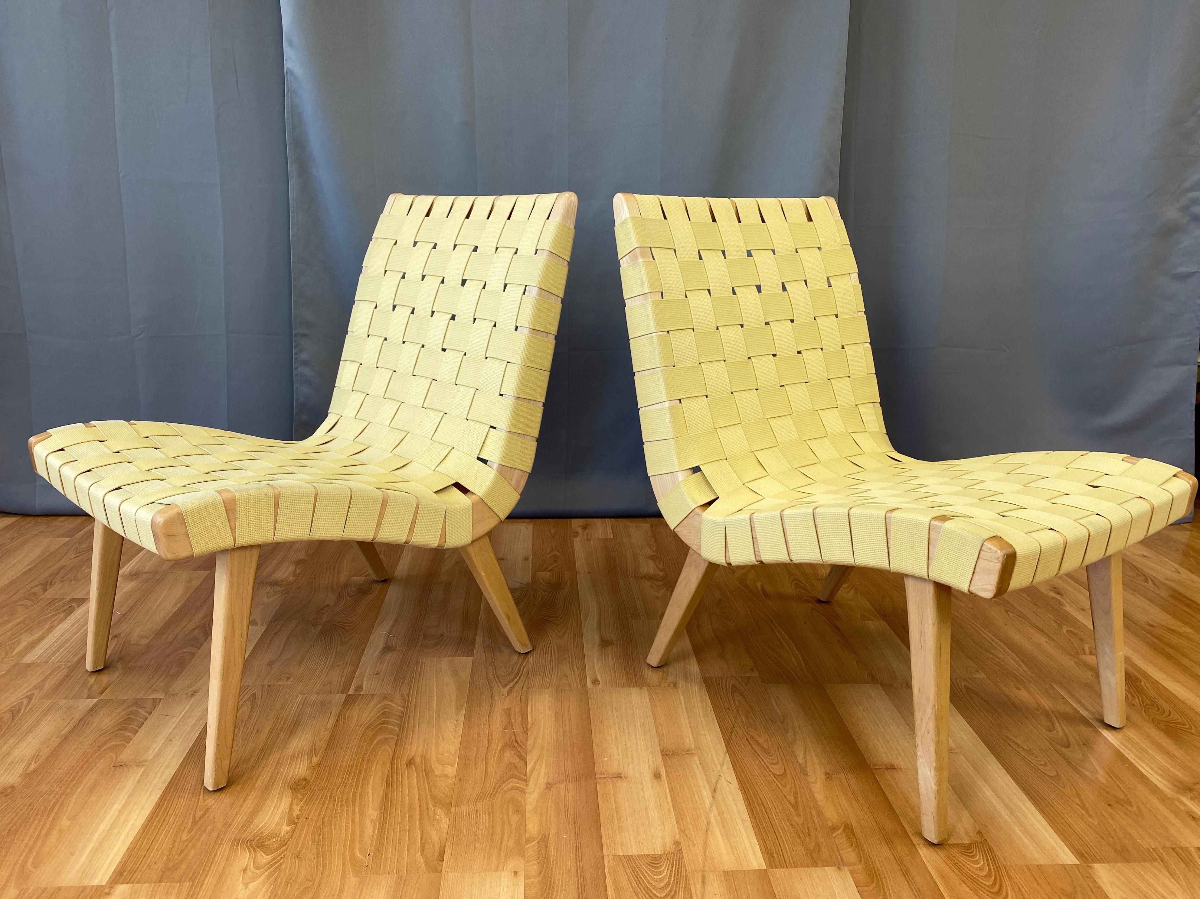 A pair of 2013 Jens Risom lounge chairs for KnollStudio in maple with maize webbing seats.

Iconic chair conceived for and produced by the Hans Knoll Furniture Company in 1943 as part of their very first collection of pieces. Designed by Risom to