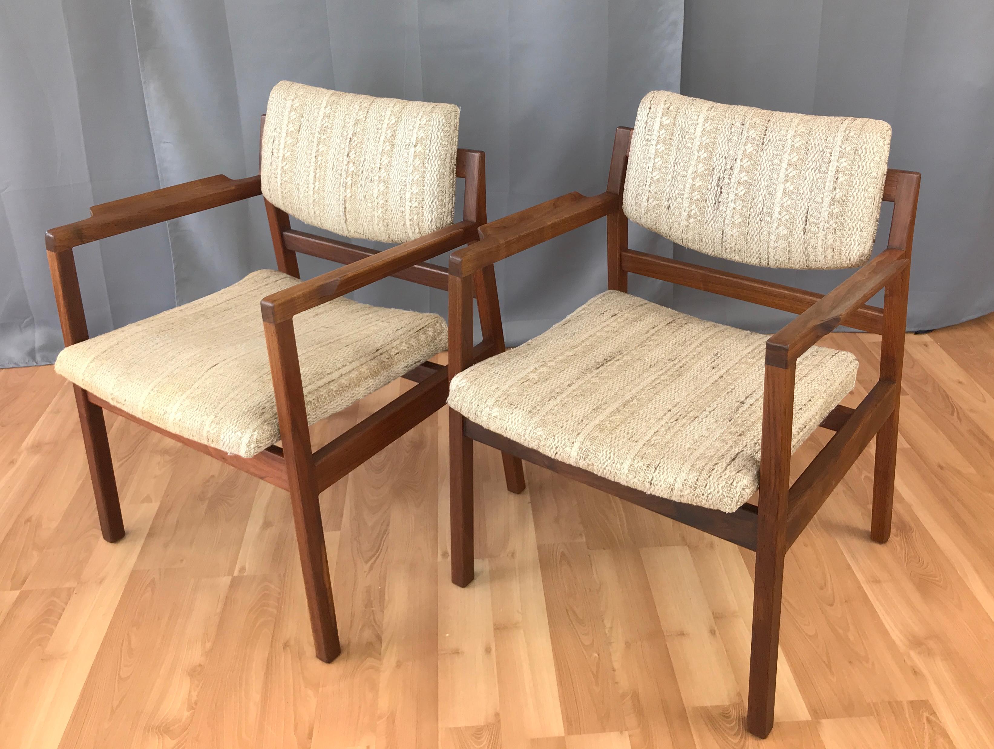 Offered here are a pair of Jens Risom designed Walnut arm chairs, circa 1960s, solid Walnut frames.