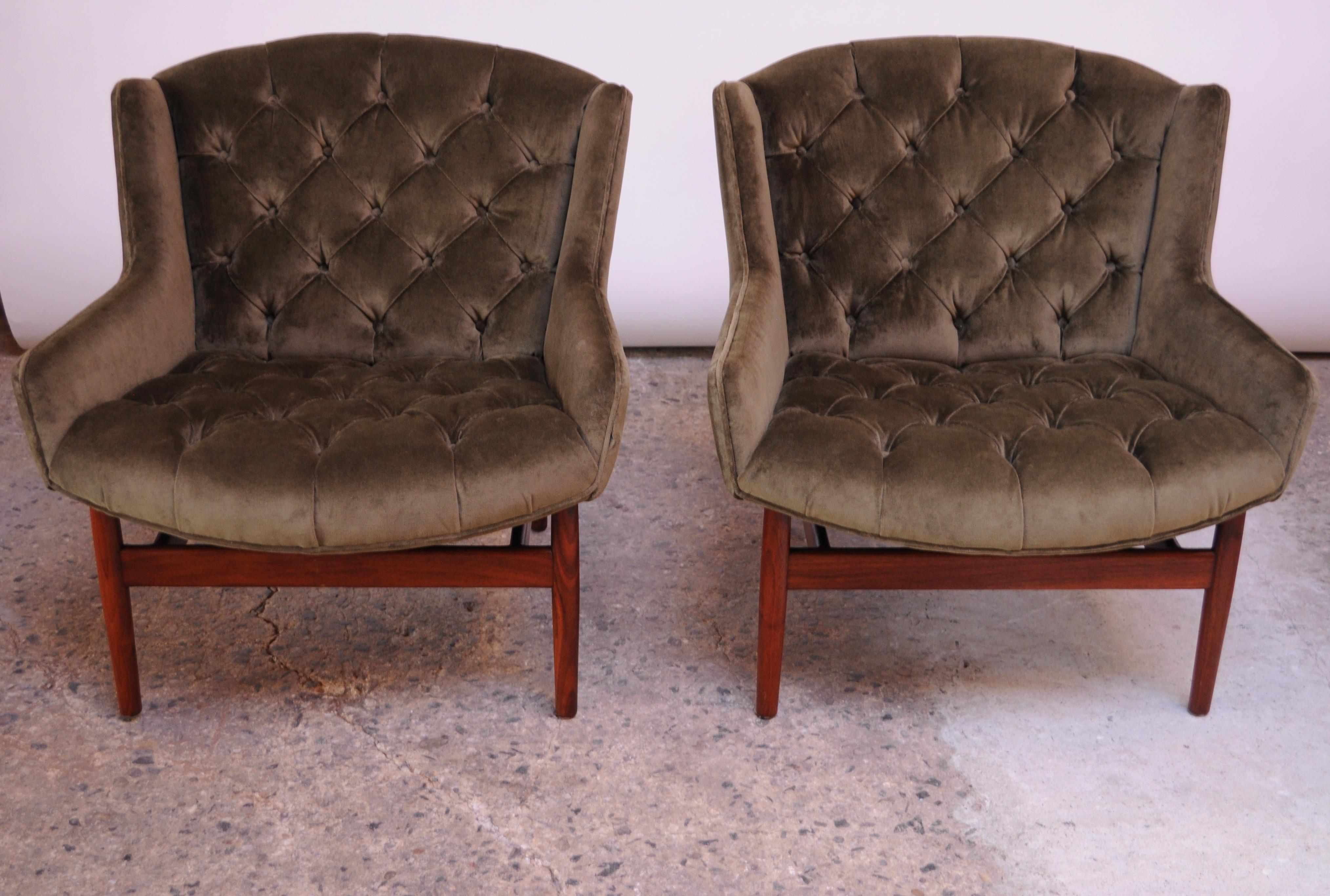 These exceptional Jens Risom Model 2137 lounge chairs supported by sculptural walnut bases are scarce examples of the 1961 design. 
They are relatively small in scale, though the seat was designed to be wide and spacious for added comfort. Features