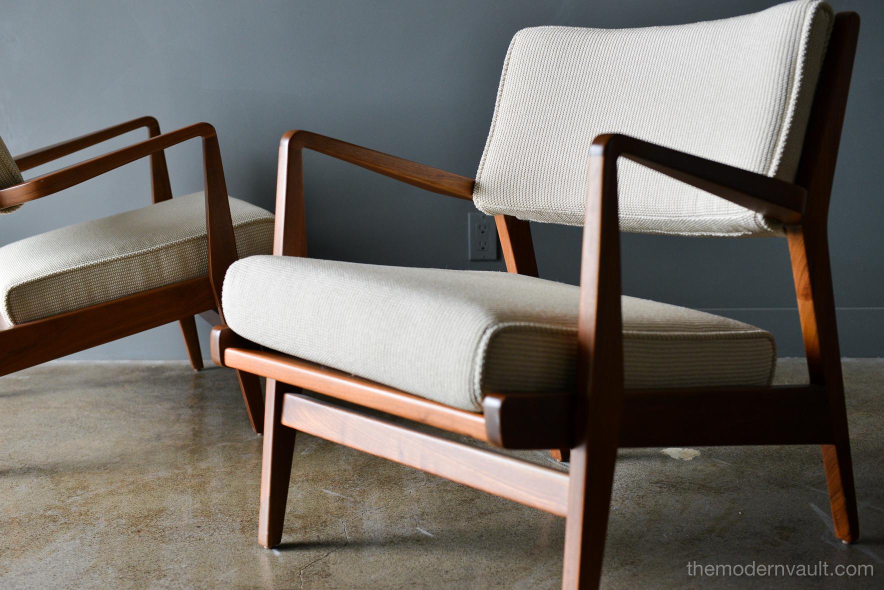 Pair of Jens Risom walnut lounge chairs, circa 1960. Restored walnut frames and new upholstery done in a beautiful woven textured fabric with period correct cushions. Beautiful lines and design, these are classic pieces for your home or