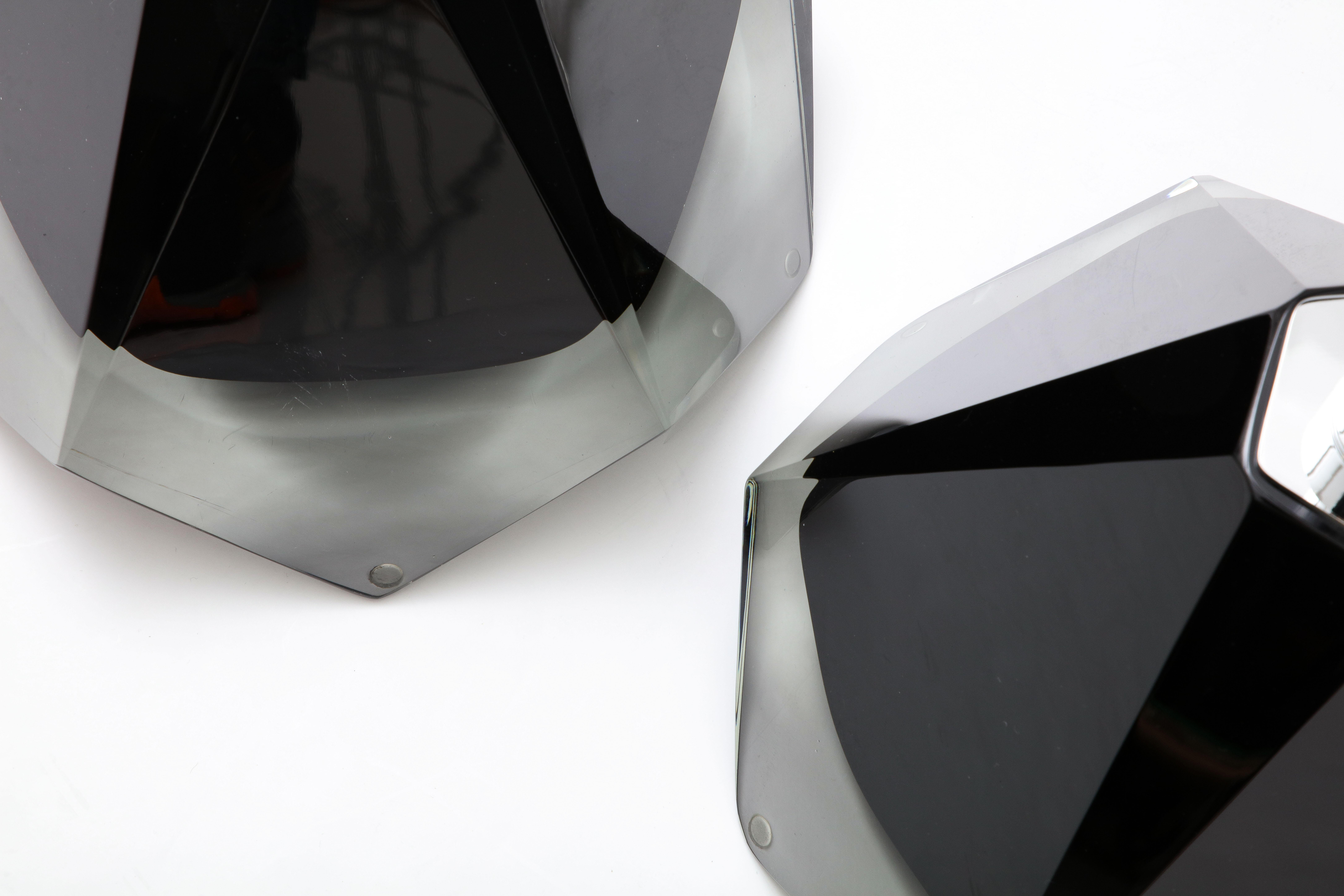 Pair of ebony black colored Murano glass lamps handcrafted by Italian master Murano Glass maker Alberto Donà. These lamps are solid and heavy and almost jewel-like with its faceted cuts throughout the glass. The design is called 