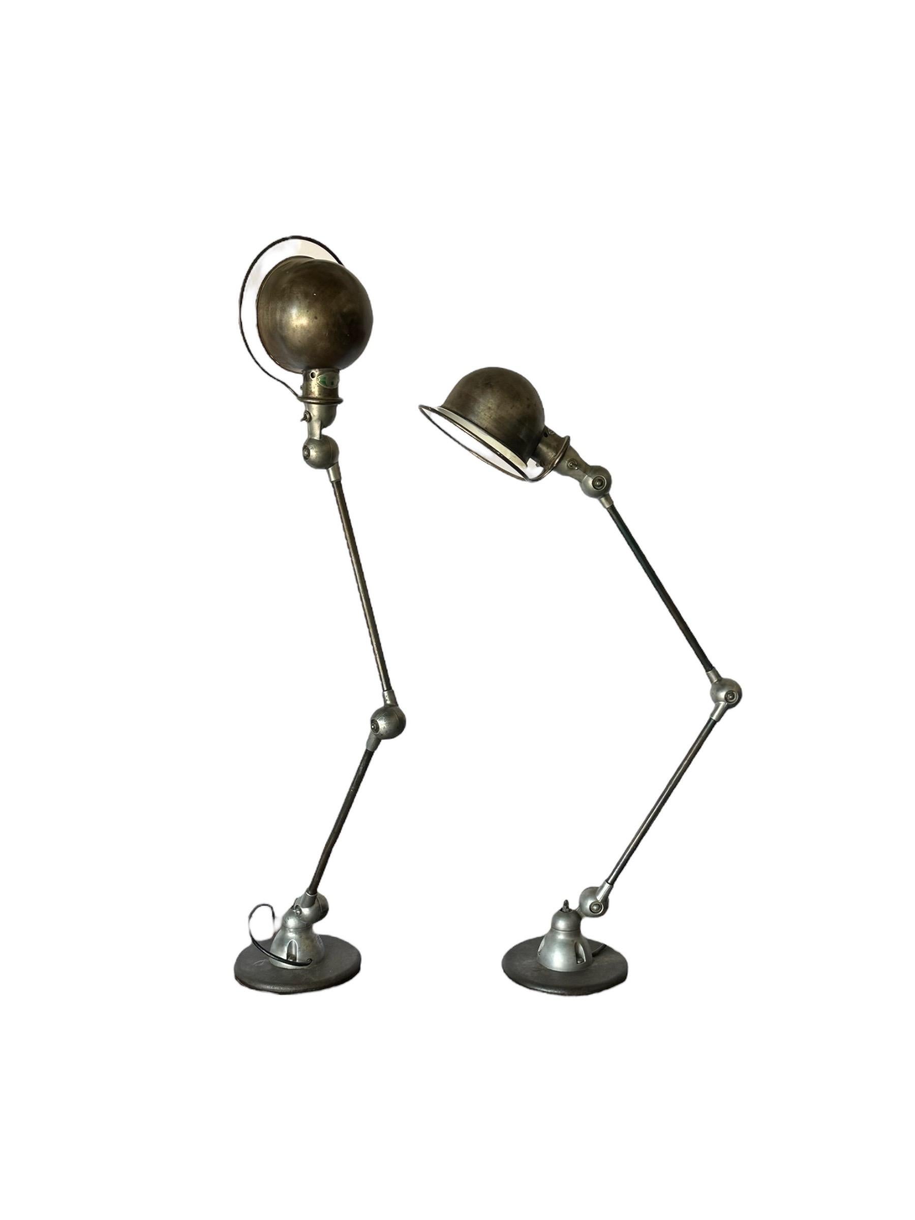 Exceptional pair of French industrial work lamps designed by Jean-Louis Domecq and produced by Jielde. With original heavy patina exuding fantastic character earned over many decades. Sold in as-acquired condition. Have not been cleaned/polished to