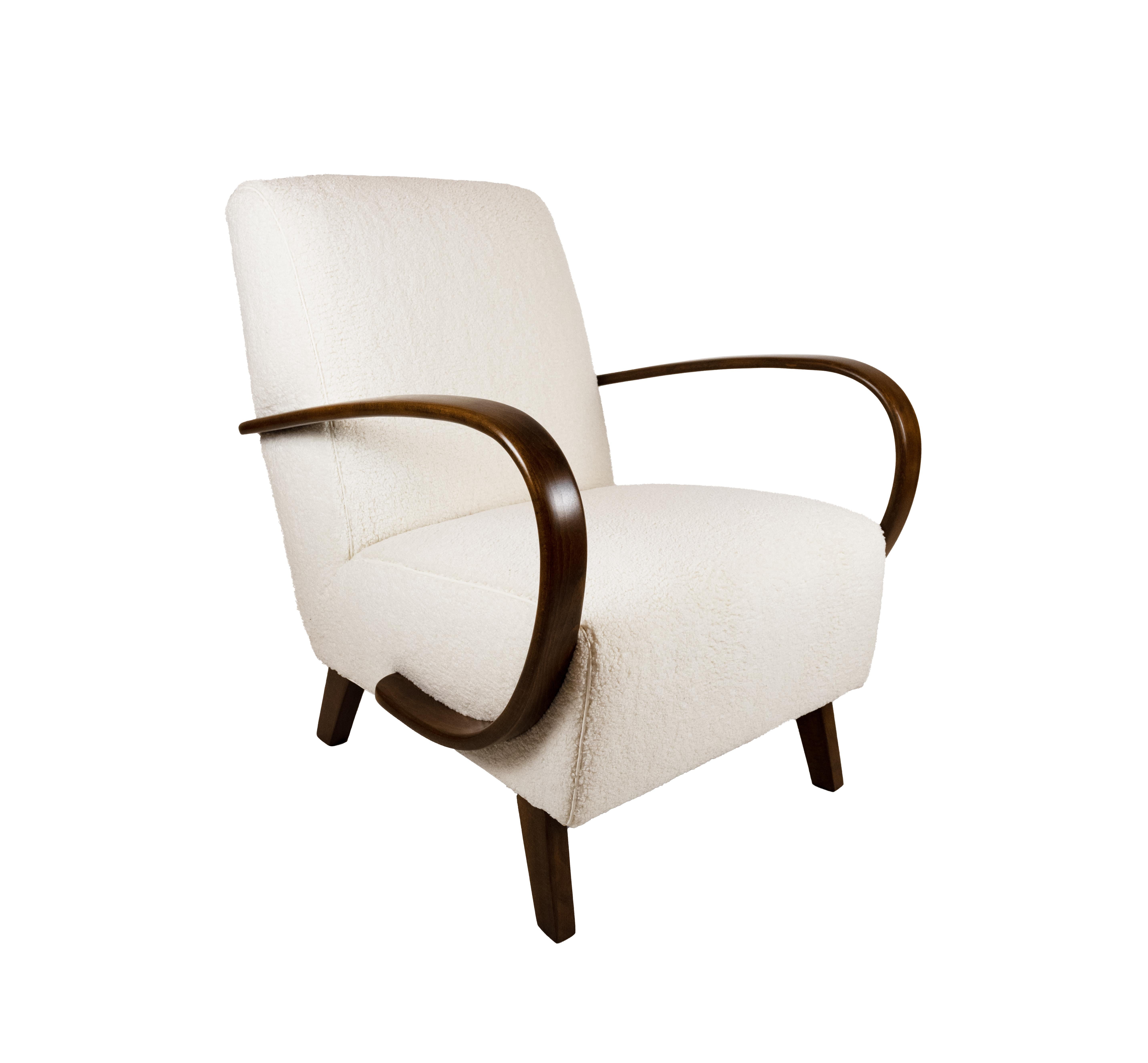 A pair of armchairs by Jindřich Halabala (1903-1978) with curved beech wood armrests, white wool back and seat, and square tapered legs. Design executed by Thonet, Czech Republic mid-20th century. Newly upholstered in Nick Cave Puff by Knoll with