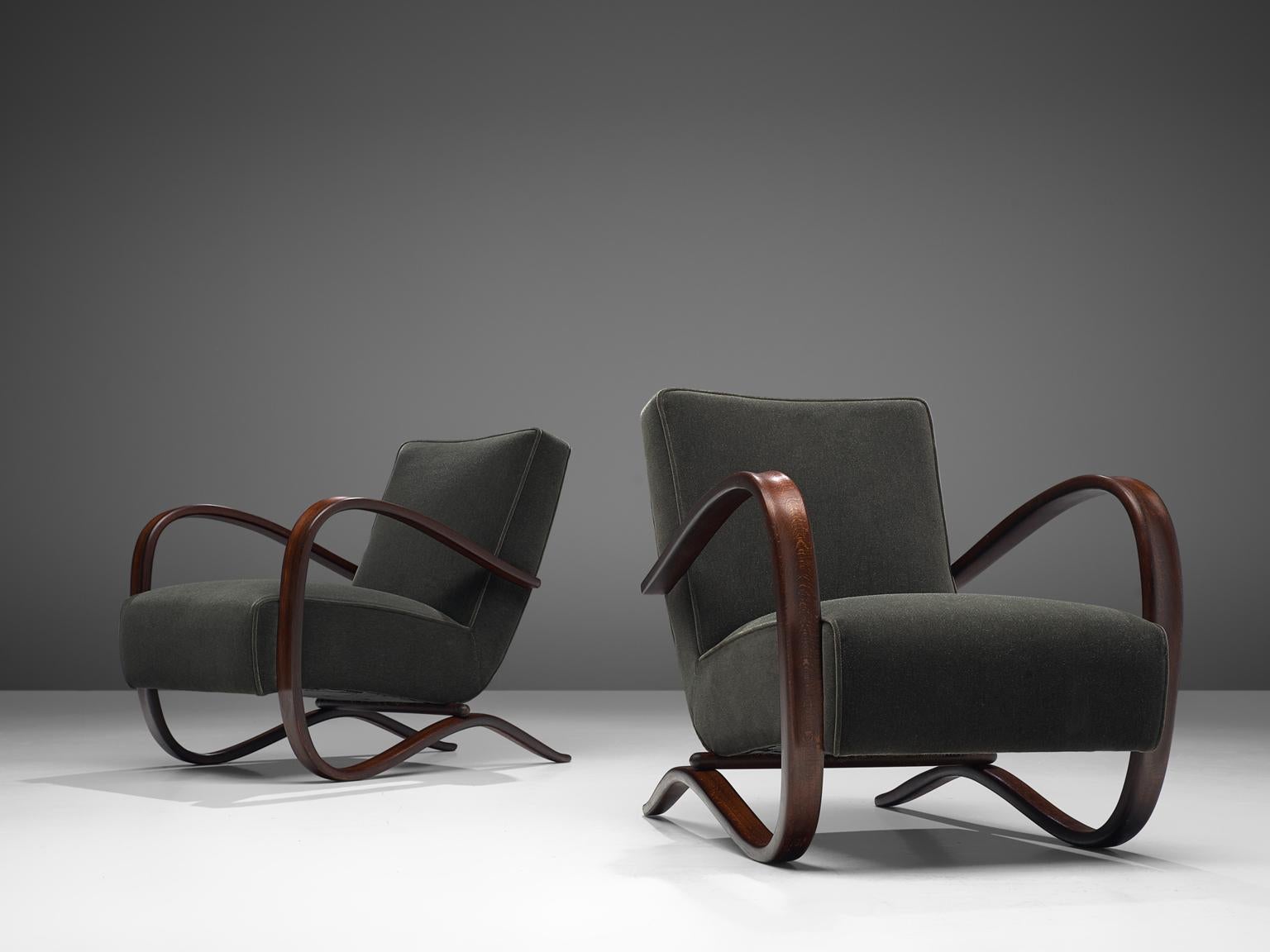 Jindrich Halabala, lounge chairs, mohair fabric and darkened wood, Czech-Republic, 1930s 

These easy chairs are designed by Jindrich Halabala in the 1930s. The main feature of this chair by Hindrich Halabala are the voluptuous curved armrests,
