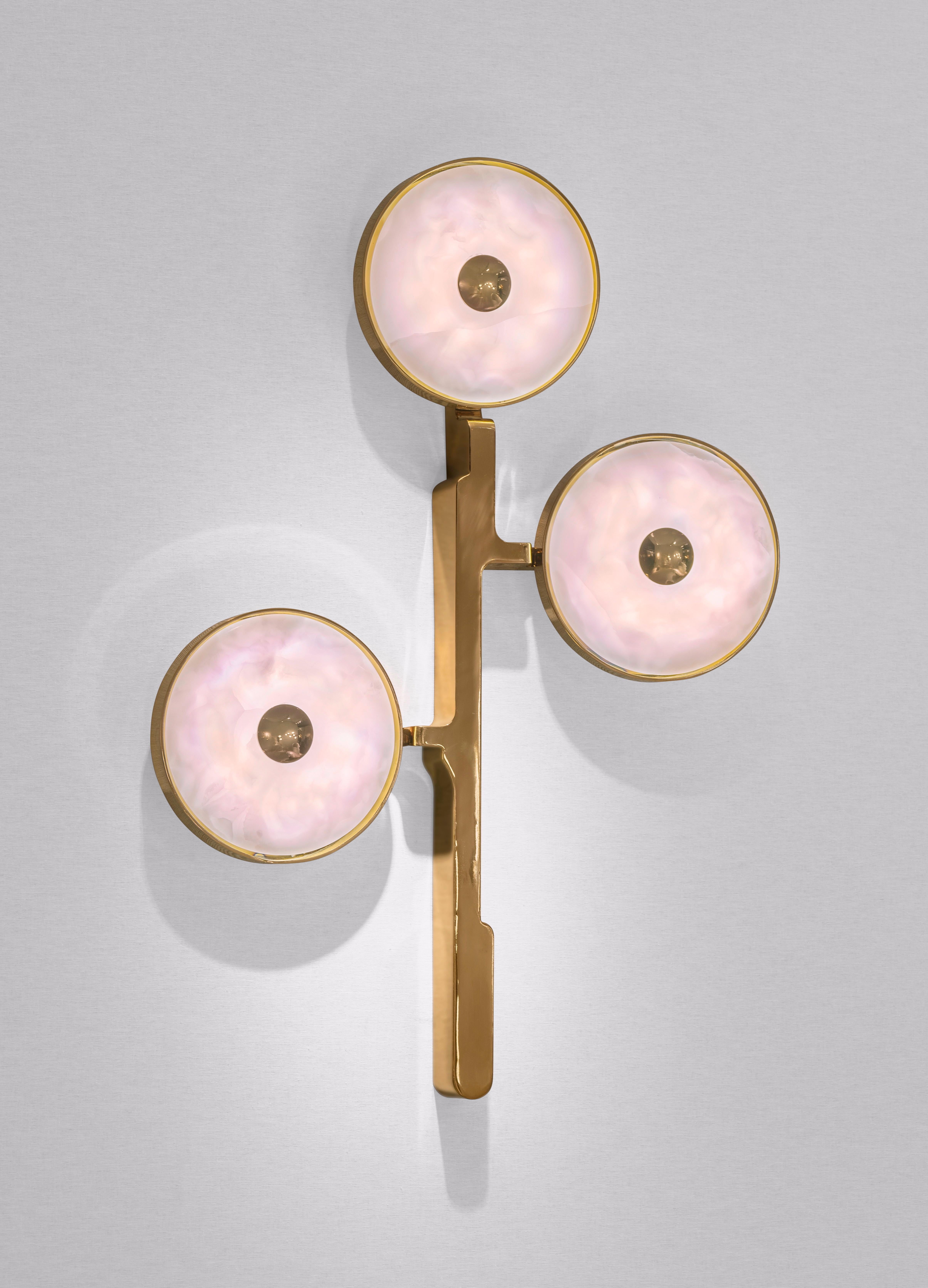 The 'JinShi Pink Jade' glamorous sconce by acclaimed design duo Studio MVW is a true jewel for the home. Pricing is for a set of two. Each sconce encompasses three retro-lit heads in natural pink jade, an exceptional gemstone with a sumptuous powder