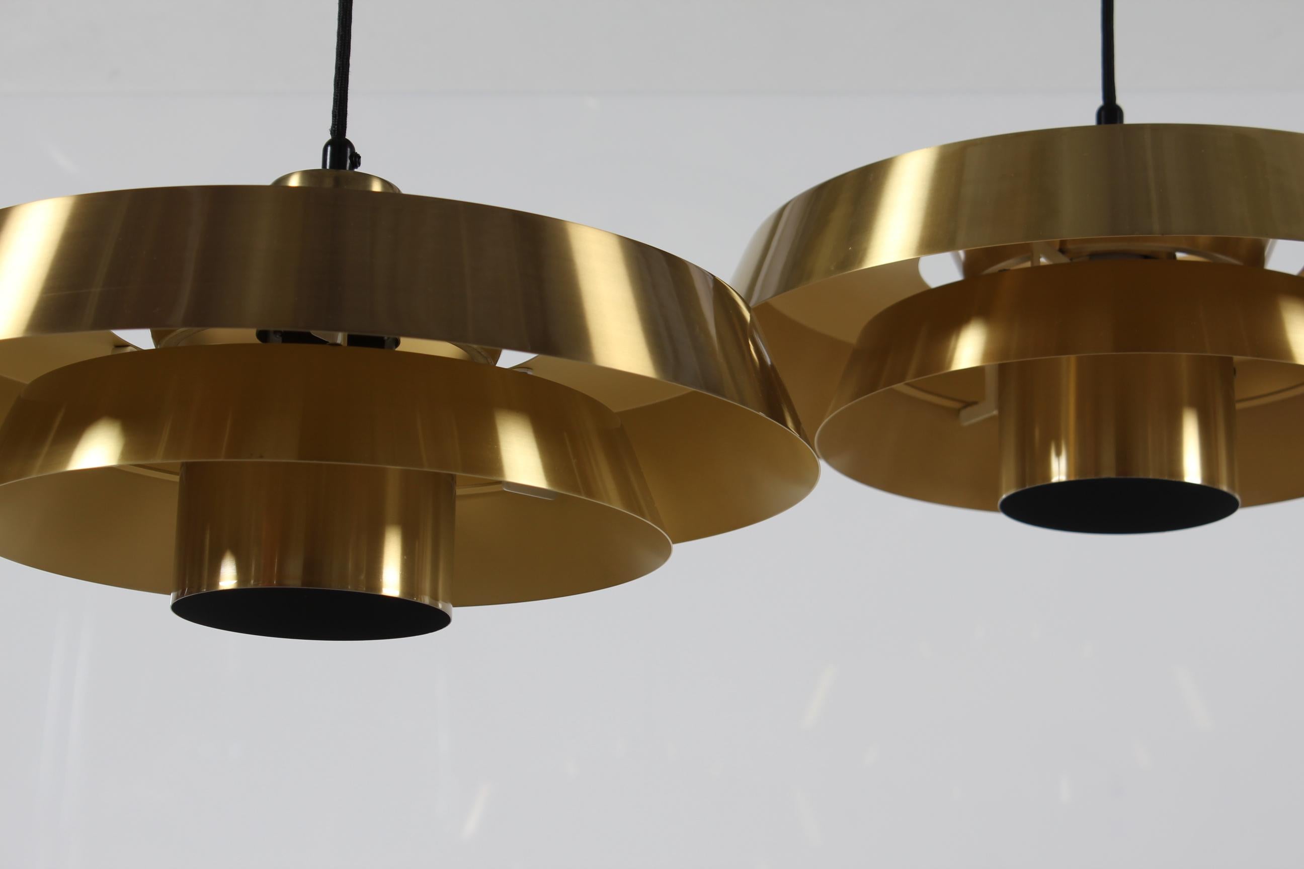 Pair of original vintage Nova ceiling pendants designed by Danish designer Jo Hammerborg in the 1960's.
They are made of brass with light warn yellow lacquer inside.
The lamps are made by the Danish lamp manufacturer Fog & Mørup in Copenhagen in