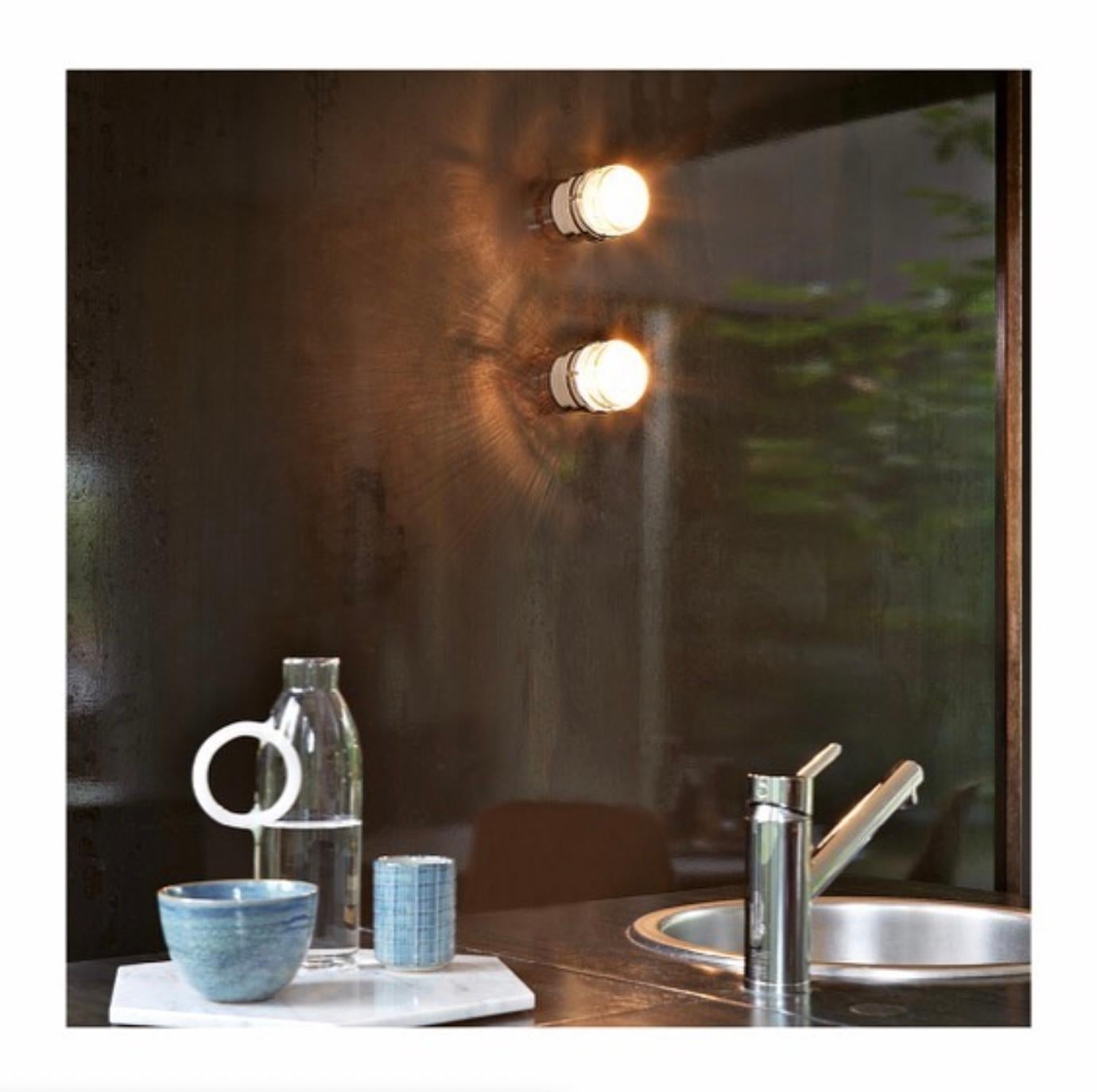 Pair of Joe Colombo 'Fresnel' outdoor wall lamps in white for Oluce.

Executed in lacquered aluminum and glass, this is one of the most refined Minimalist Italian designs of the midcentury and an icon for Colombo. Originally designed in 1966, this