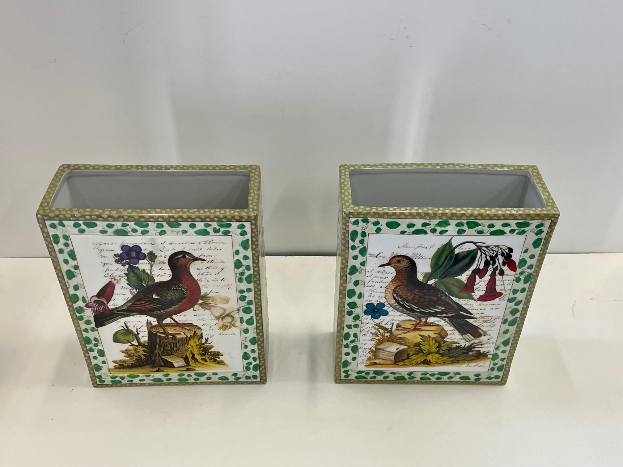 Imaginative pair of porcelain vases embellished by renowned artist and designer John Derian utilizing his classic decoupage technique and depicting flowers, birds and romantic snippets of script.