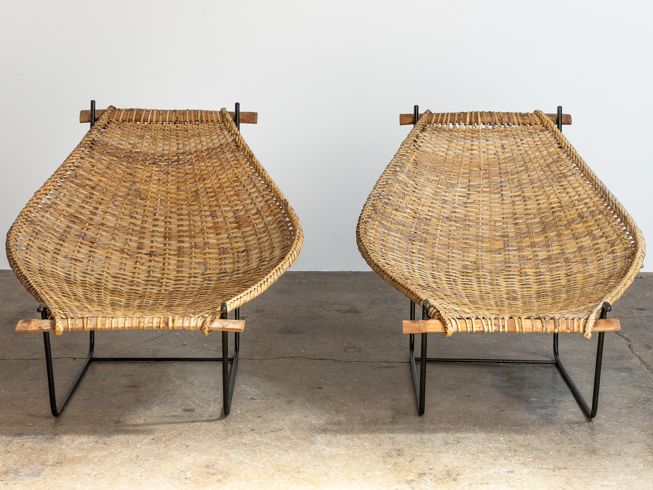 Pair of modernist Duyan lounge chair designed by John Risley.  Minimal iron frame supports a curved sling, finished with a beautiful braided edge. Bamboo supports at each end. A delightful mélange of traditional weaving craft and modern design. The