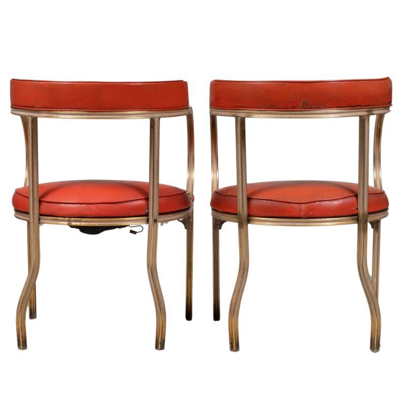 A vintage pair of John Van Koert for Troy Sunshade 'Cymbal' arm chairs in patinated gilt aluminum. A super chic pair of shaped gilt metal chairs in a striking design that seamlessly blends mid-century aesthetics with timeless sophistication. The