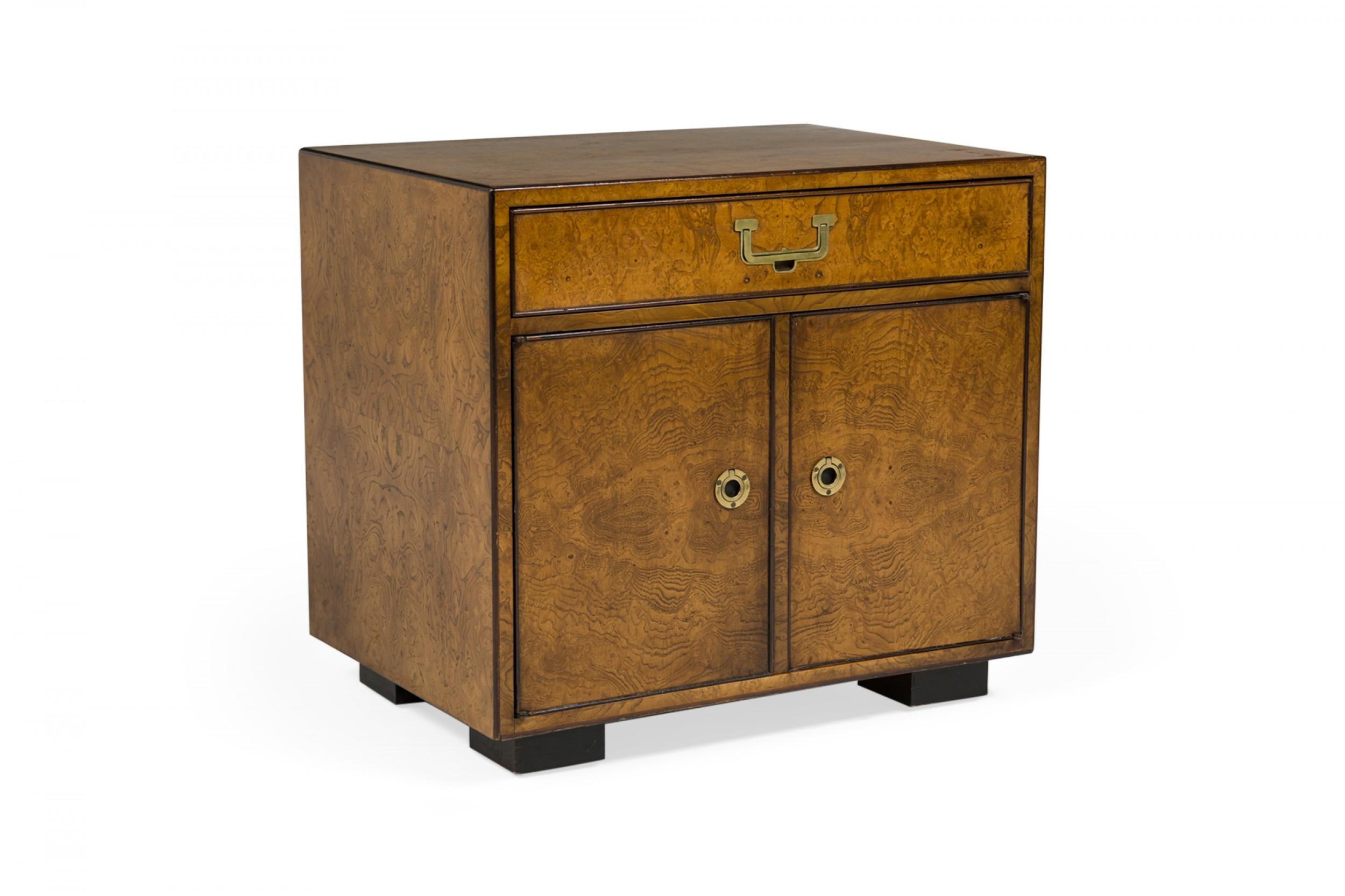 Pair of American mid-century nightstands / commodes with a burl wood veneer, single drawer with brass pulls, and two cabinet doors with brass pulls below. (JOHN WIDDICOMB)(PRICED AS PAIR)
 