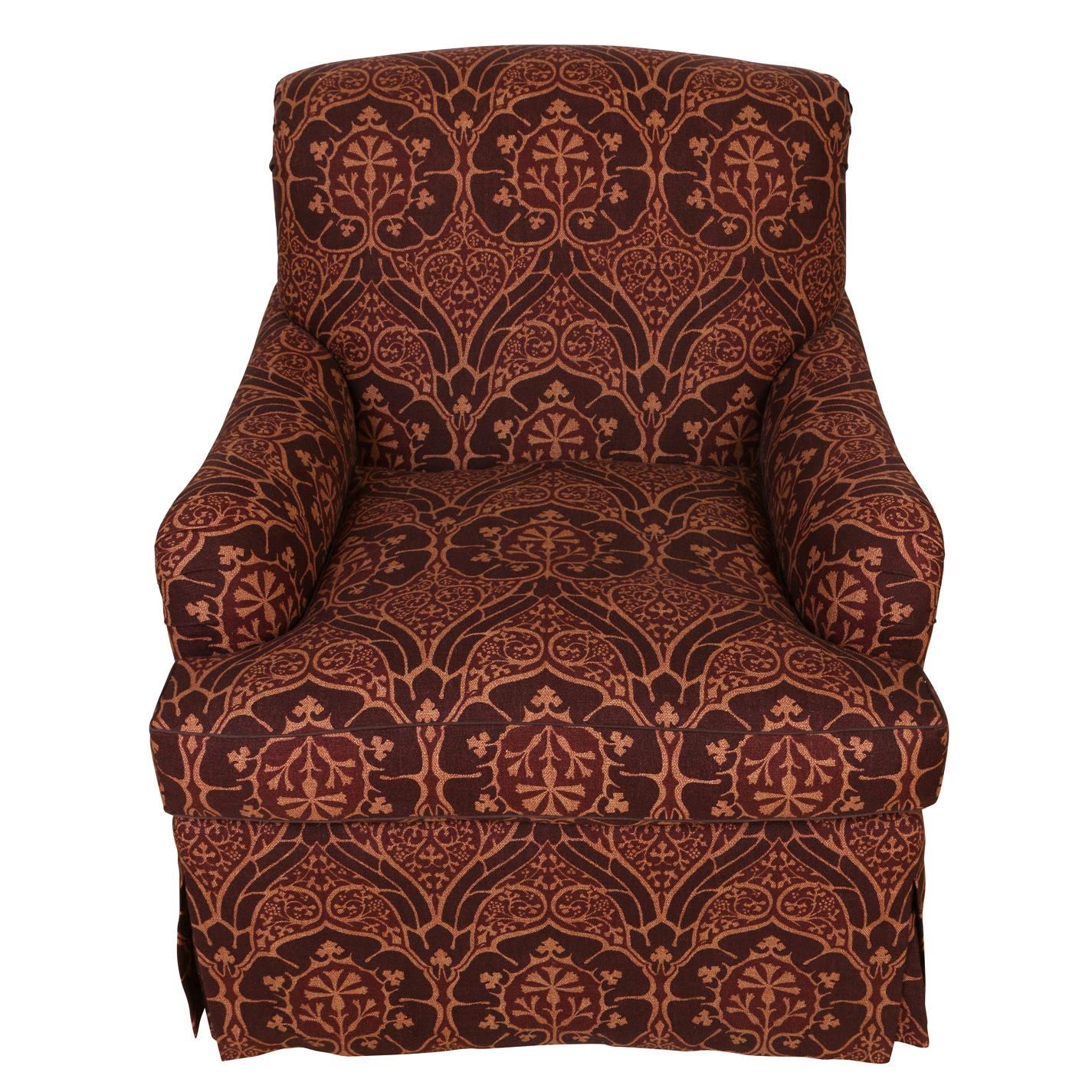 A pair of Jonas custom upholstered club chairs in a burgundy print fabric with gold highlights with a geometric floral motif. Extremely comfortable chairs have a contemporary style with a tight back, loose cushion and low profile arms. Made in New