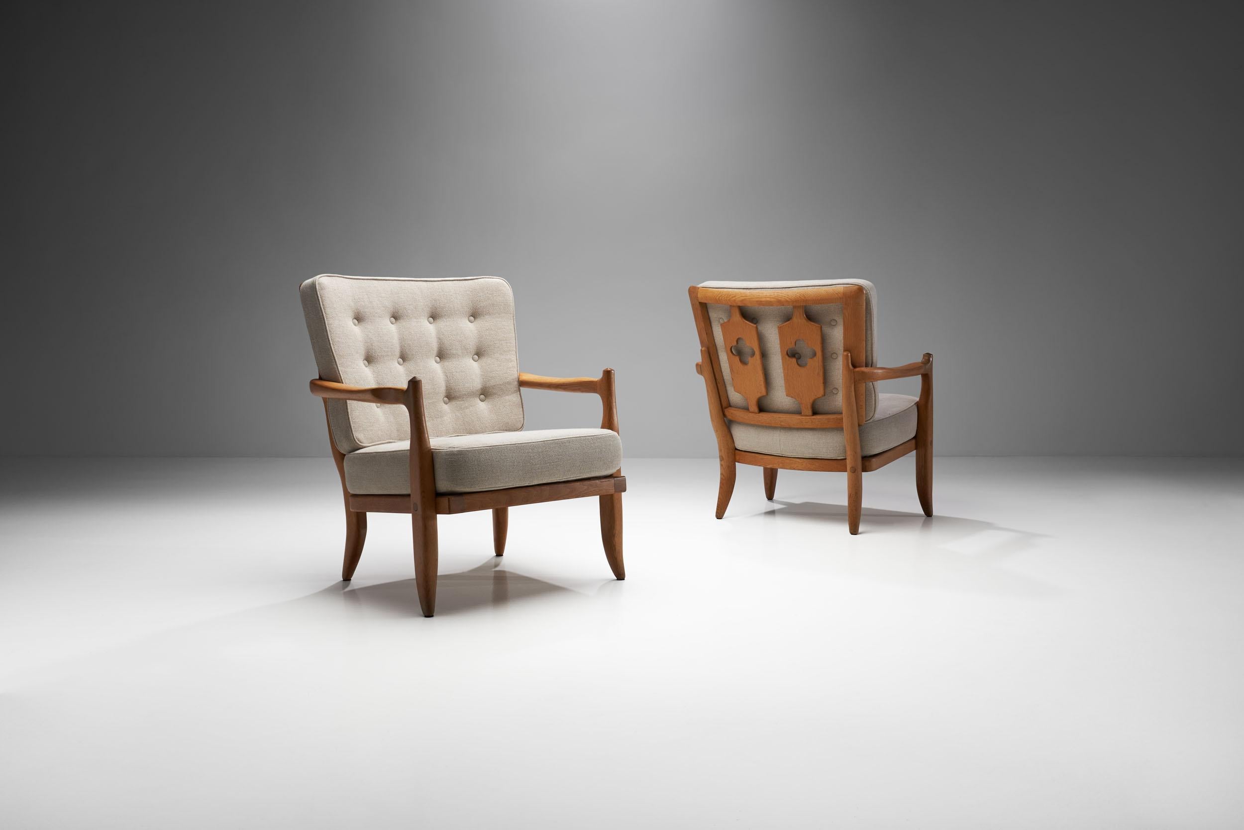 A pair of mid-century “José” oak armchairs by Guillerme et Chambron, Votre Maison edition. Made of high-quality oak with a beautiful fabric, this pair of the famous José chair is truly eye catching.

The carefully carved geometrical patterns on the