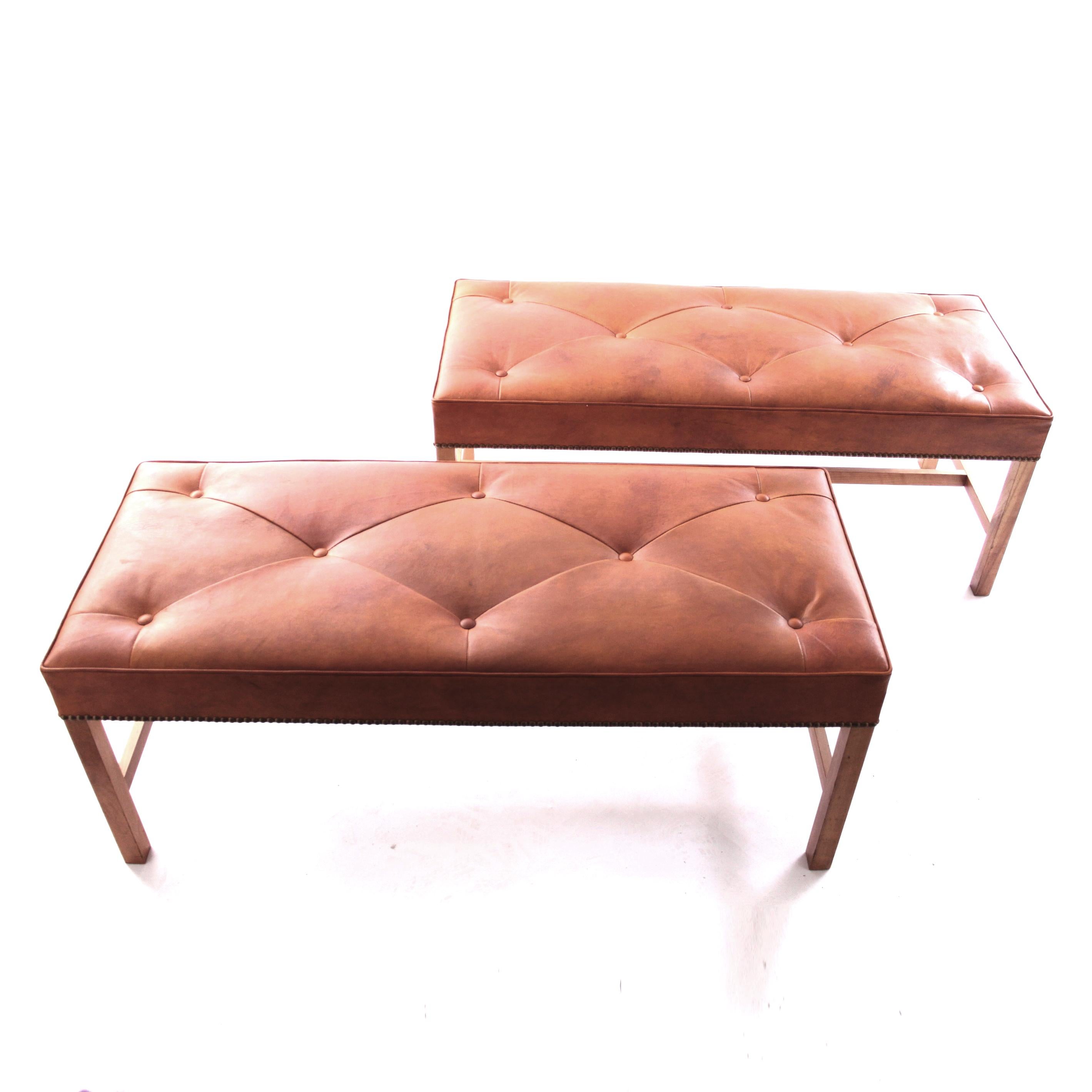 JOSEF FRANK AND SVENSKT TENN   - SCANDINAVIAN MODERN

A beautiful pair of benches by Josef Frank for Svenskt Tenn, Model 2082, mahogany frame and Niger leather with nails. 

The model 2082 was designed by Josef Frank in 1950 and the square legs have