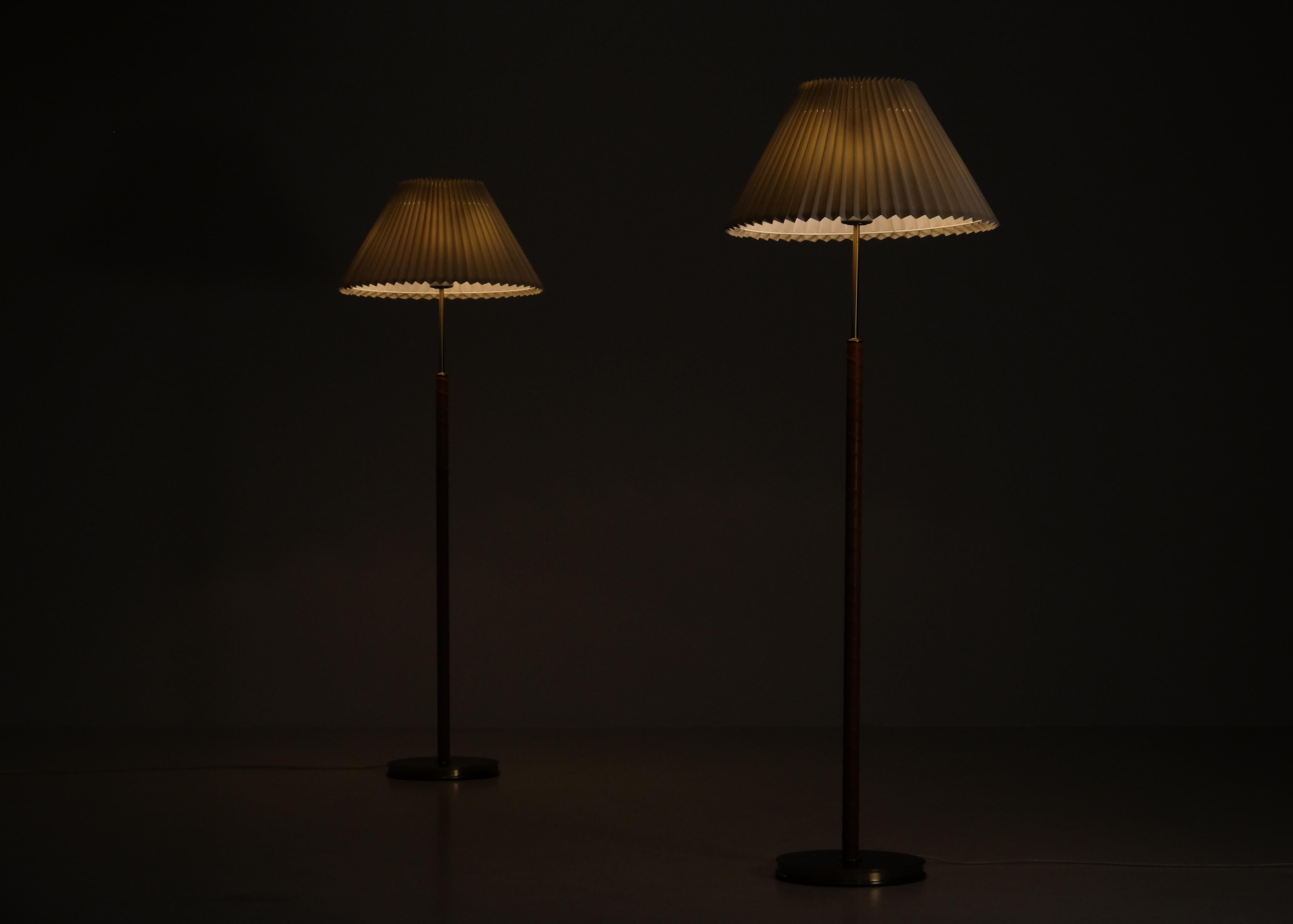 Pair available. Designed by Josef Frank, model 2148, produced by Svenskt Tenn.
With 4 lights each, controlled with two discreet push switches, allowing two different lighting moods. 
With a bespoke ivory fabric tapered shade and leather. 
Please