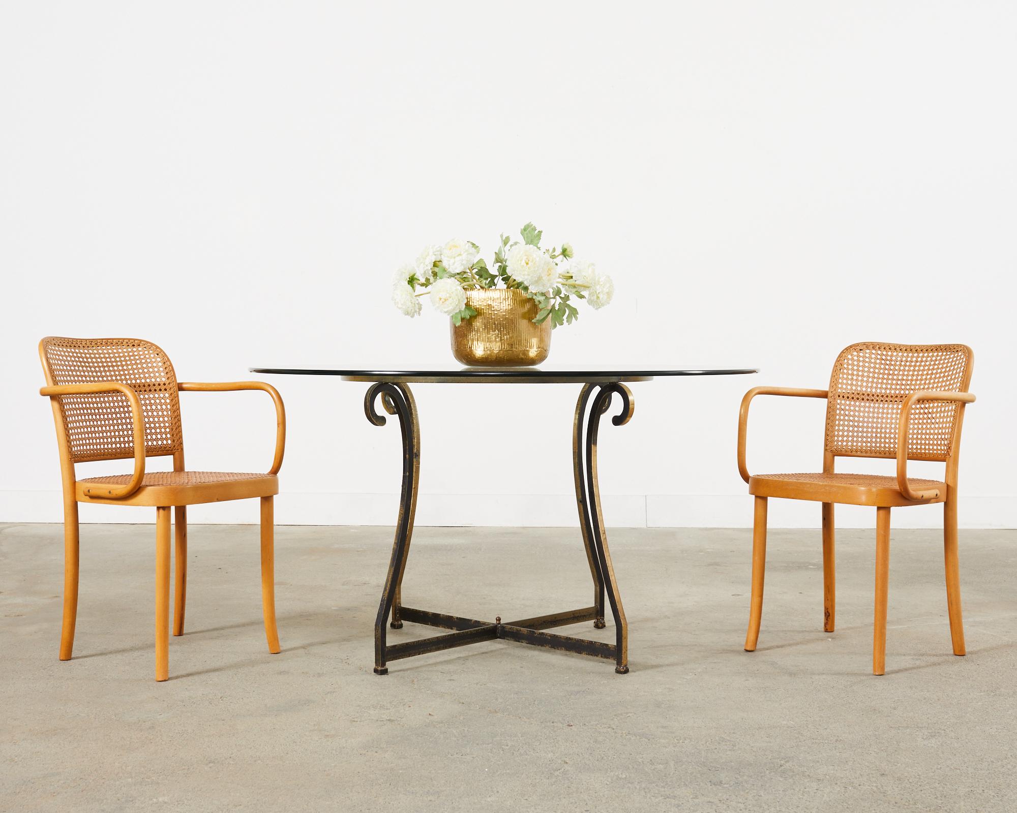 Rare pair of No. 811 Thonet chairs or Prague chairs designed by Josef Hoffman. The chairs feature an iconic bentwood frame design with square shaped arms and a caned seat and back. Excellent joinery and craftsmanship given age and use with a