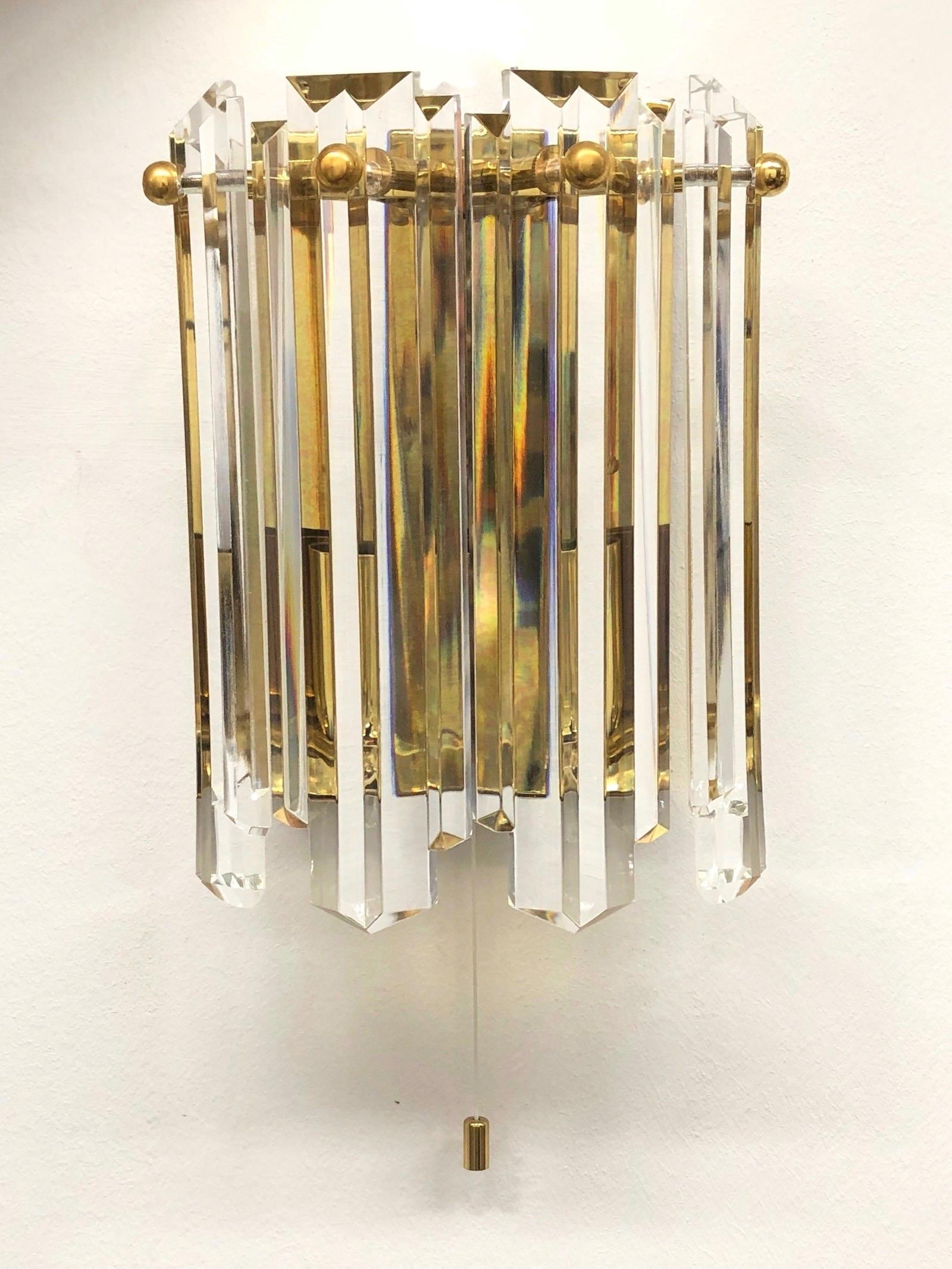 A pair of sconces found on an estate sale in Vienna, Austria. Gorgeous thick cut crystal glass with gilded metal fixture. Great size and stunning design. Brings a touch of elegance to the room. Each fixture requires two European E 14 candelabra bulb