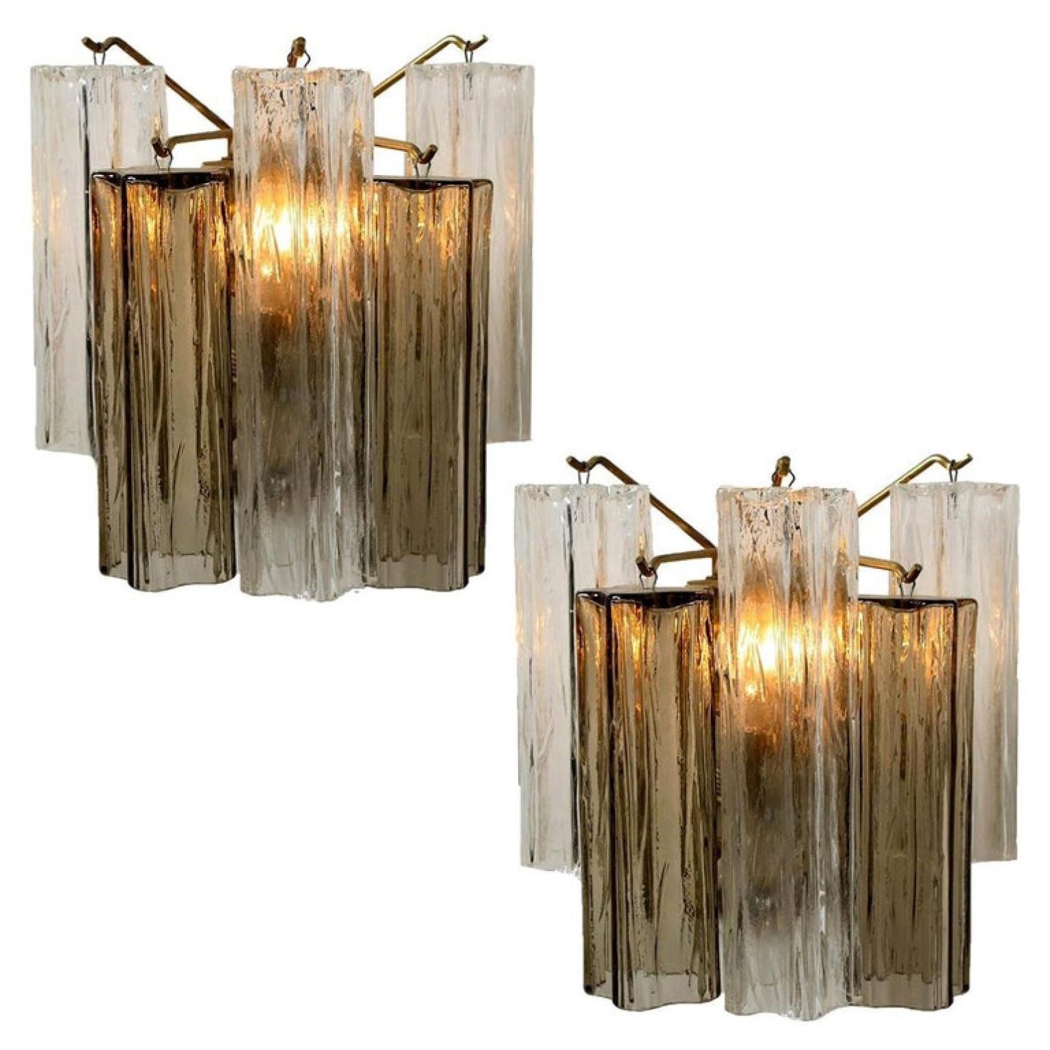 A wonderful pair of Murano glass tronchi wall lights designed by J.T. Kalmar for Kalmar Franken, Vienna, Austria. Manufactured in circa 1960s. These wall lights are handmade and a high quality pieces. Murano tubes in smoked and clear glass hanging