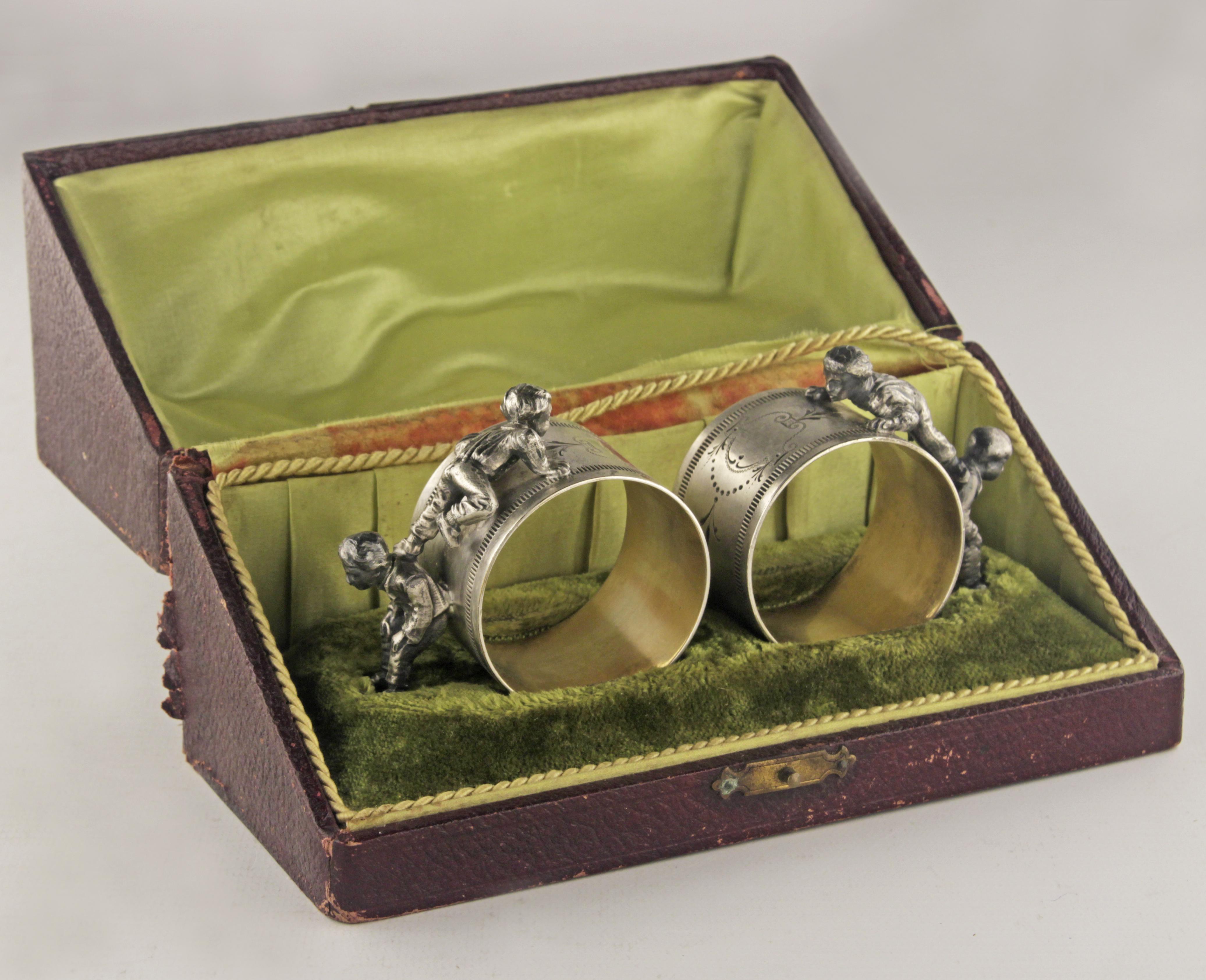 Pair of early 20th century Jugendstil/Art Nouveau silver napkin rings and decorative box by german manufacturer Württembergische Metallwarenfabrik (WMF)

By: Württembergische Metallwarenfabrik (WMF)
Material: silver, wood, thread, velvet, cord,