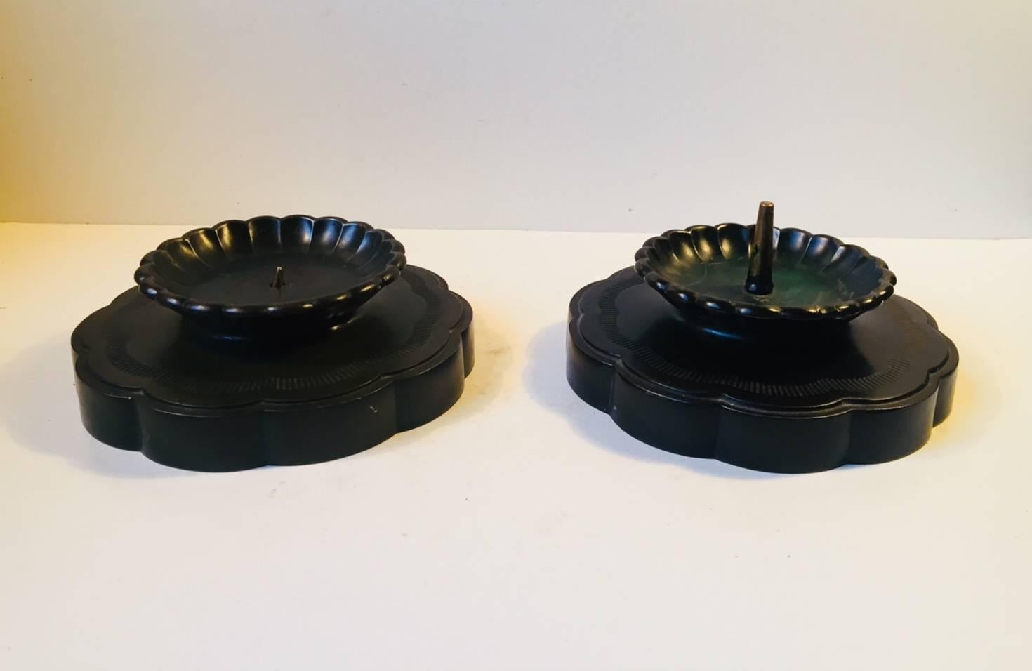 A pair of green patinated disko metal candleholders for large Bloc candles/church candles. Designed by Just Andersen in Denmark during the 1930s. Design number: 1870. The candle pin/holder is a bit smaller to one of the bases and may have been