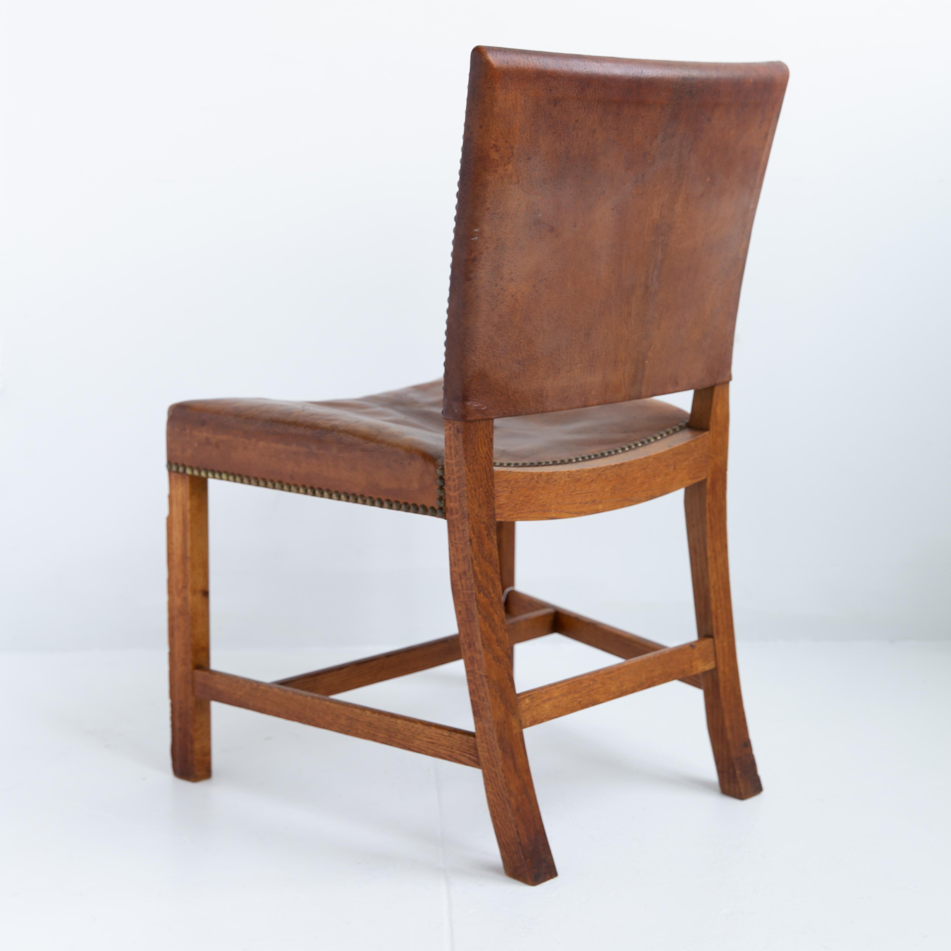 A pair of Kaare Klint designed Barcelona dining chairs (Model 3758) in excellent vintage condition. Originally manufactured by Rud. Rasmussens Snedkerier in 1927, these mid-century modern chairs originating in Denmark feature a Cuban mahogany frame,