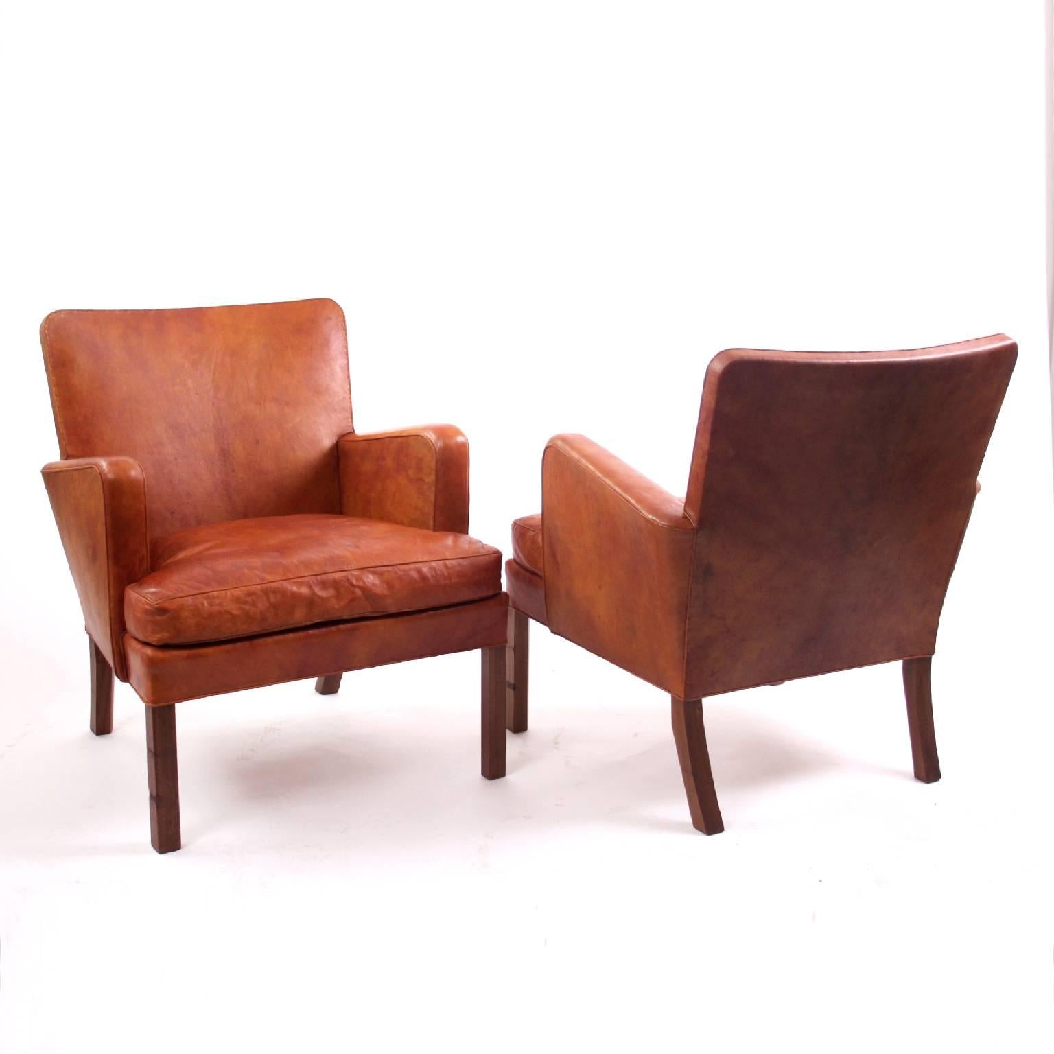 Kaare Klint & Rud Rasmussen

A rare pair of Kaare Klint chairs Model KK5313, manufactured by Rud Rasmussen Cabinetmakers.

The frame is crafted from solid mahogany and the seat/back is upholstered with patinated Niger leather. 

Underside of