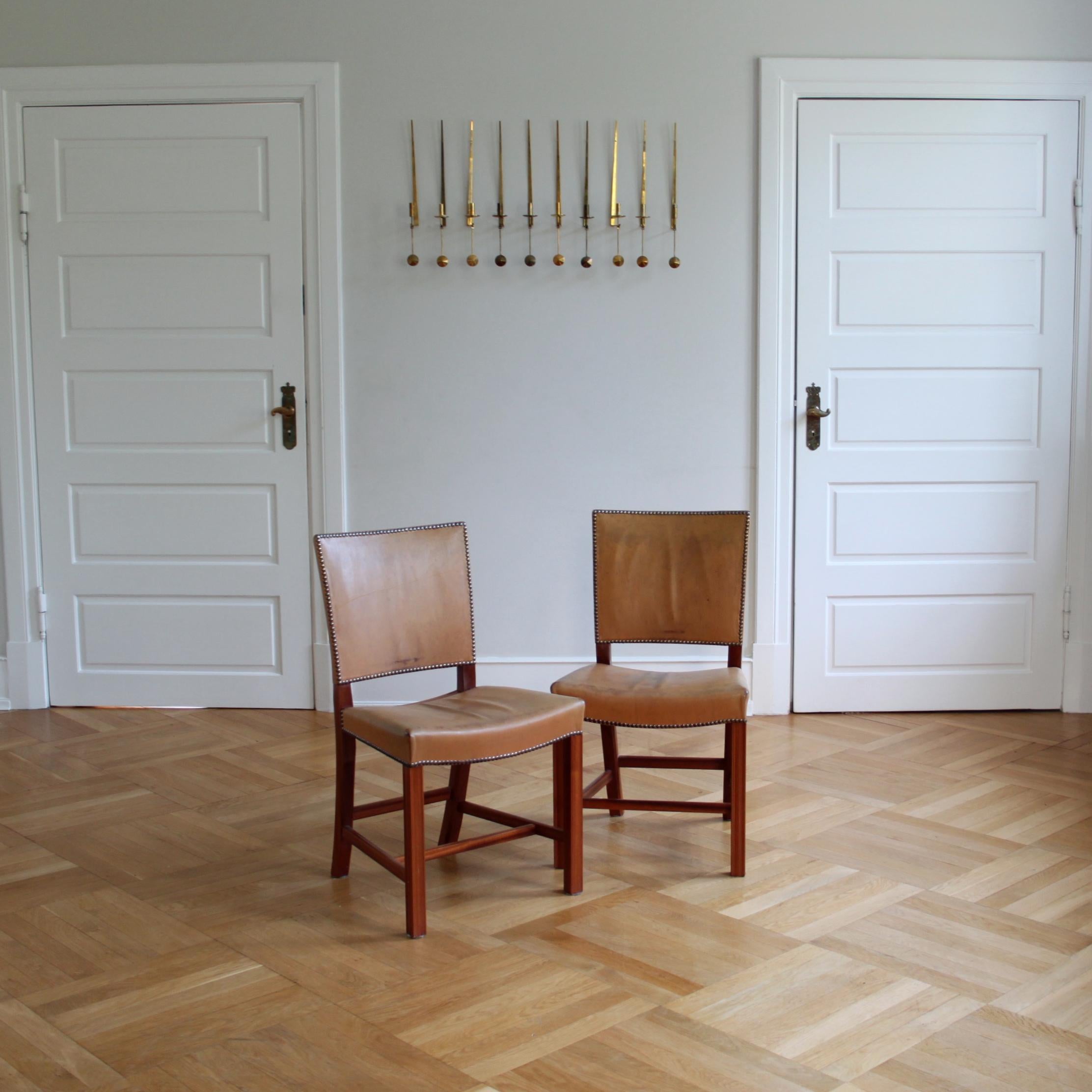 Kaare Klint & Rud Rasmussen Snedkerier - Scandinavian Modern Design.

An beautiful pair of Kaare Klint red chairs, executed by cabinetmaker Rud. Rasmussen, Denmark.

Profiled legs of mahogany, seat and back upholstered with leather with patina and