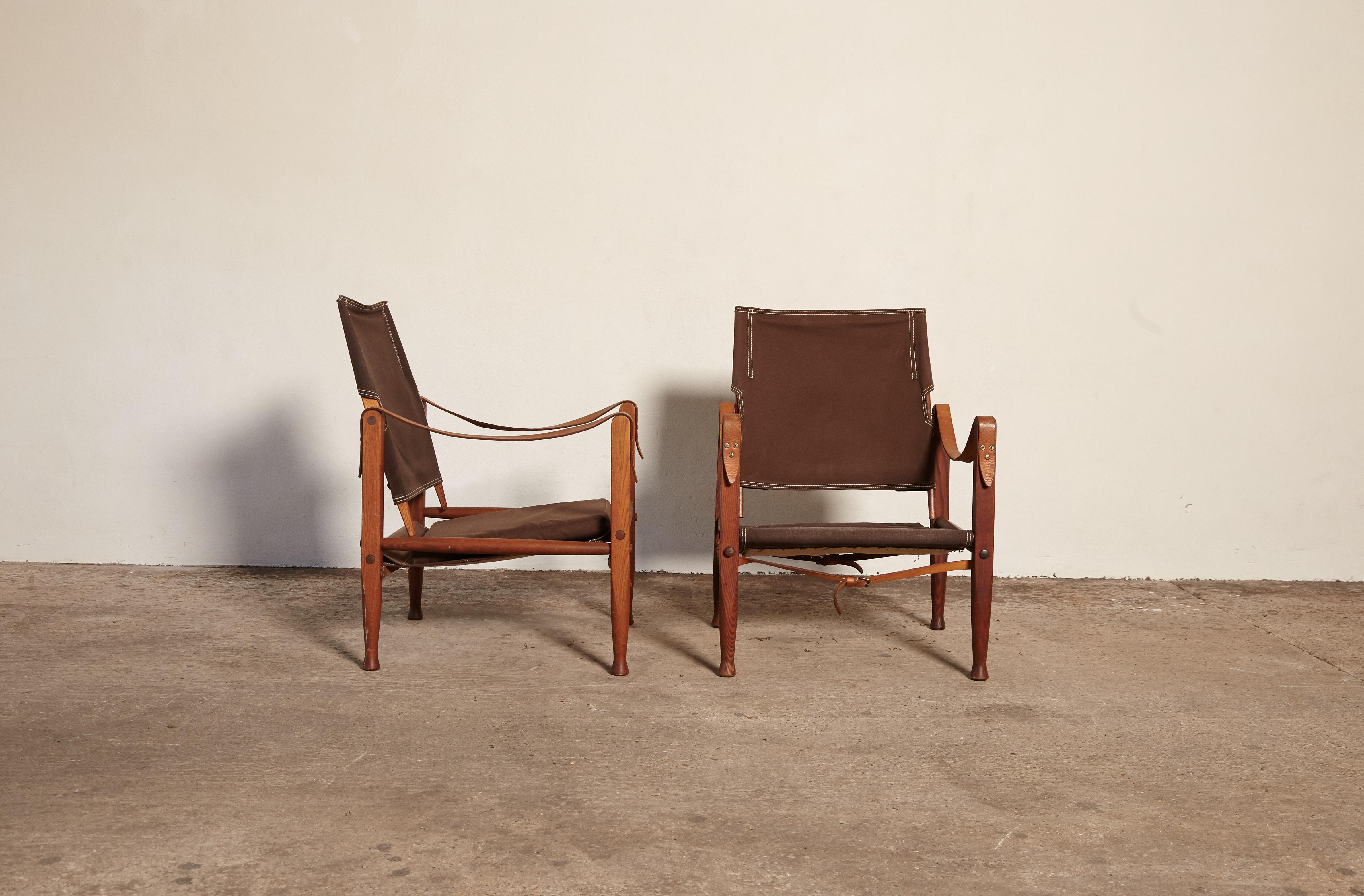 A pair of Kaare Klint safari chairs, made by Rud Rasmussen, Denmark. Original brown canvas and ashwood. Fast shipping worldwide.