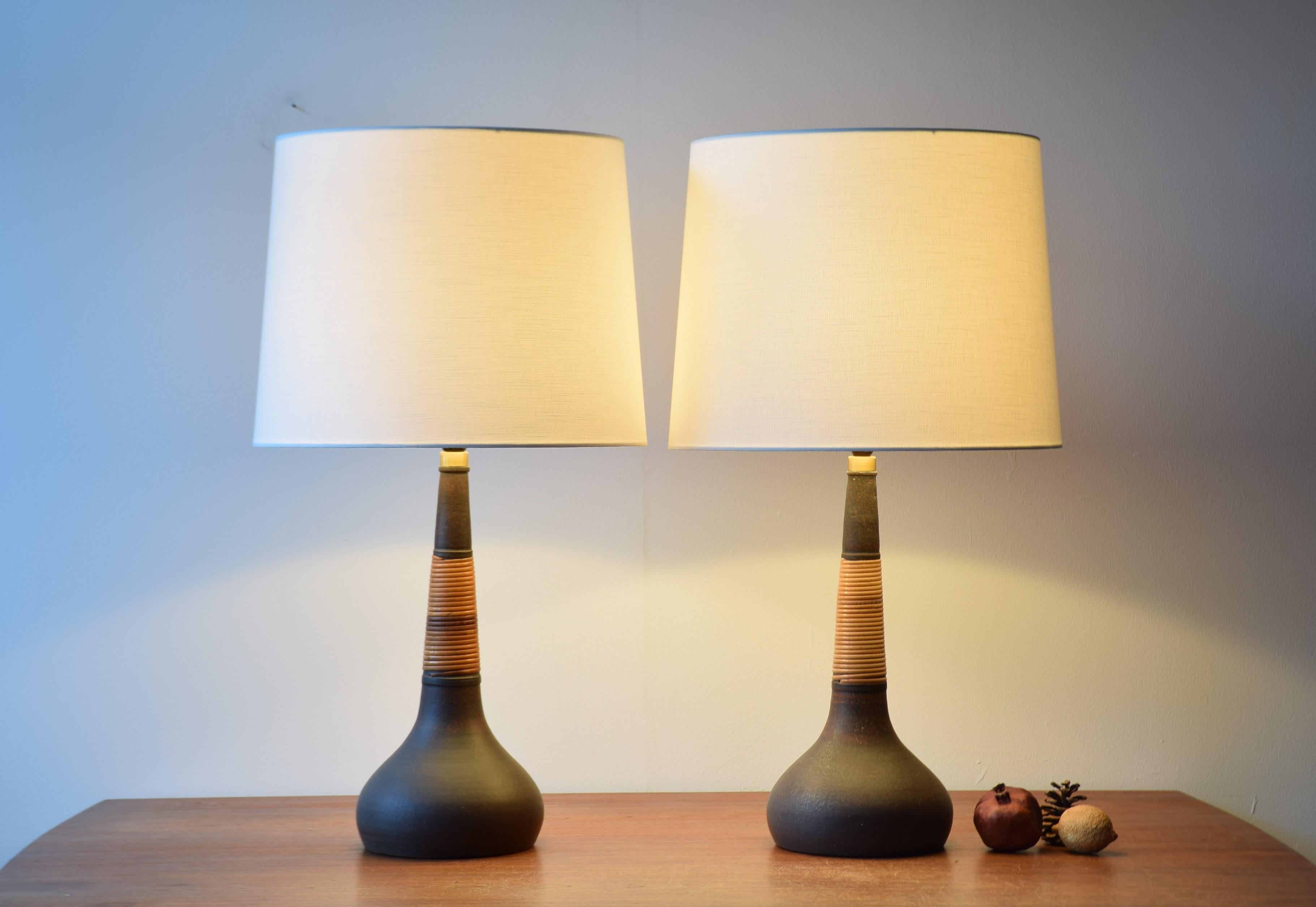 Rare pair of table lamps from the Danish pottery Kähler (HAK) made for Le Klint. The lampshades are included.

The lamps are made of unglazed ceramic wrapped with cane for a stylish and warm look.
Most likely designed by Esben Klint and made ca