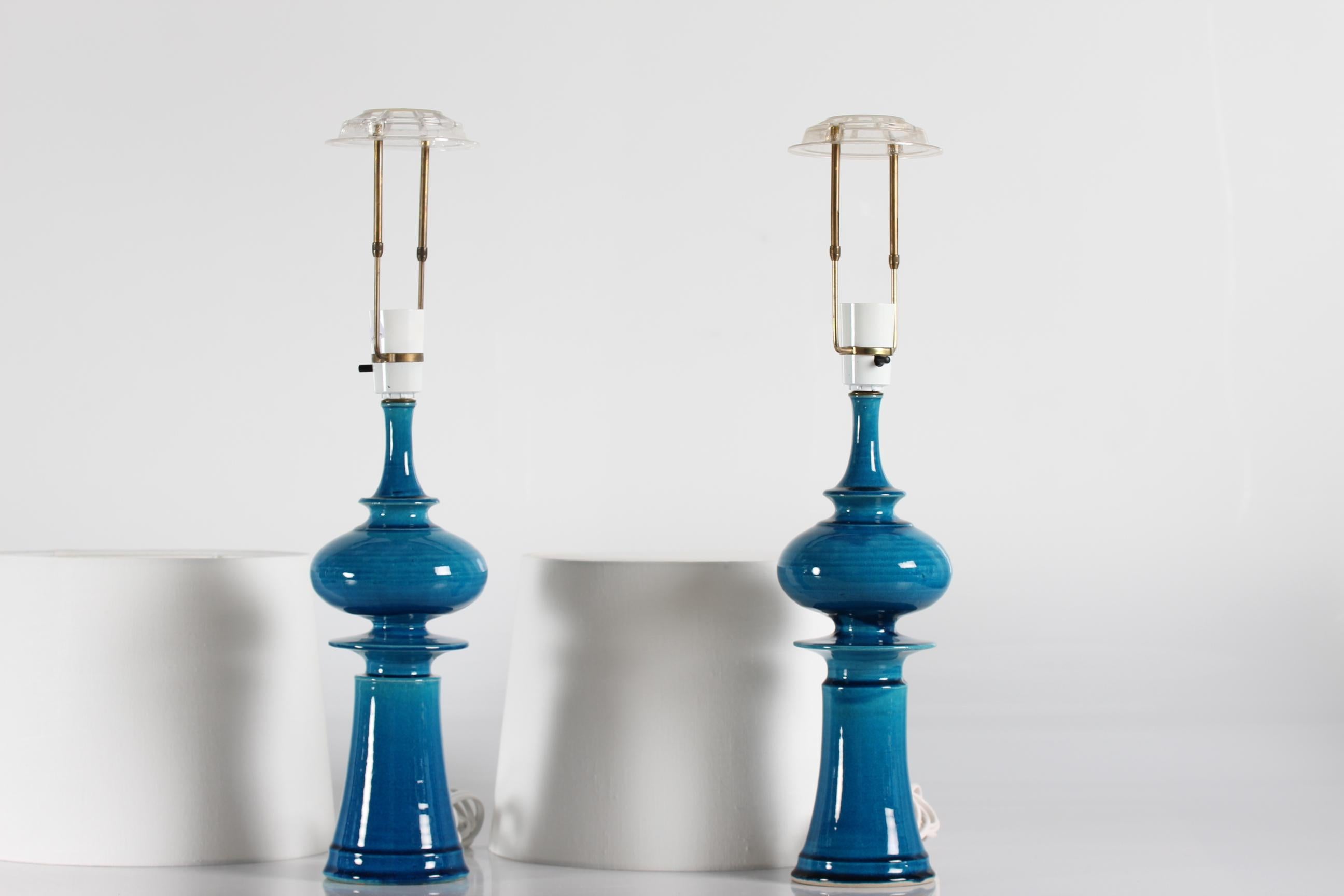 Pair of tall sculptural table lamps by Poul Erik Eliasen for the ceramic studio Kähler (HAK). 
The lamps are made from stoneware with glossy turquoise colored glazed and manufactured ca 1970s.

Marked on bottom with HAK (for Herman August Kähler)