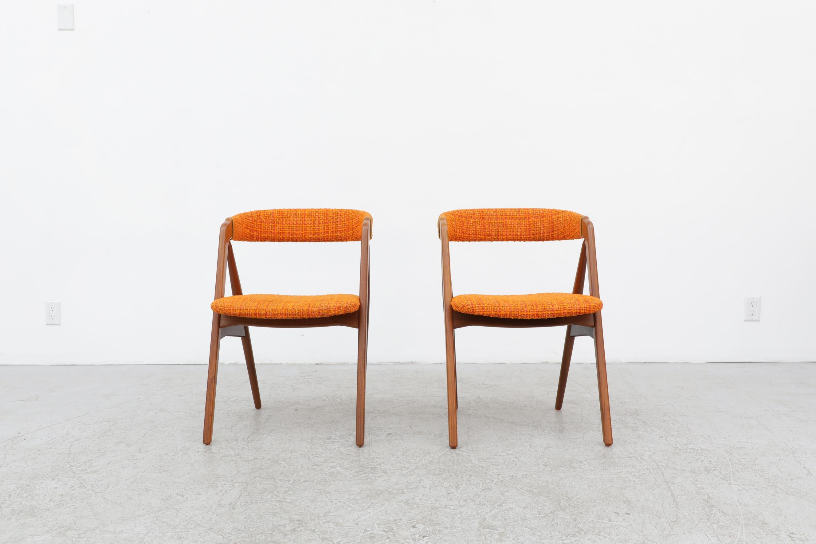 Pair of Kai Kristiansen chairs with original orange boucle upholstered seats. In original condition with visible scuffs and patina. Wear is consistent with their age and use.