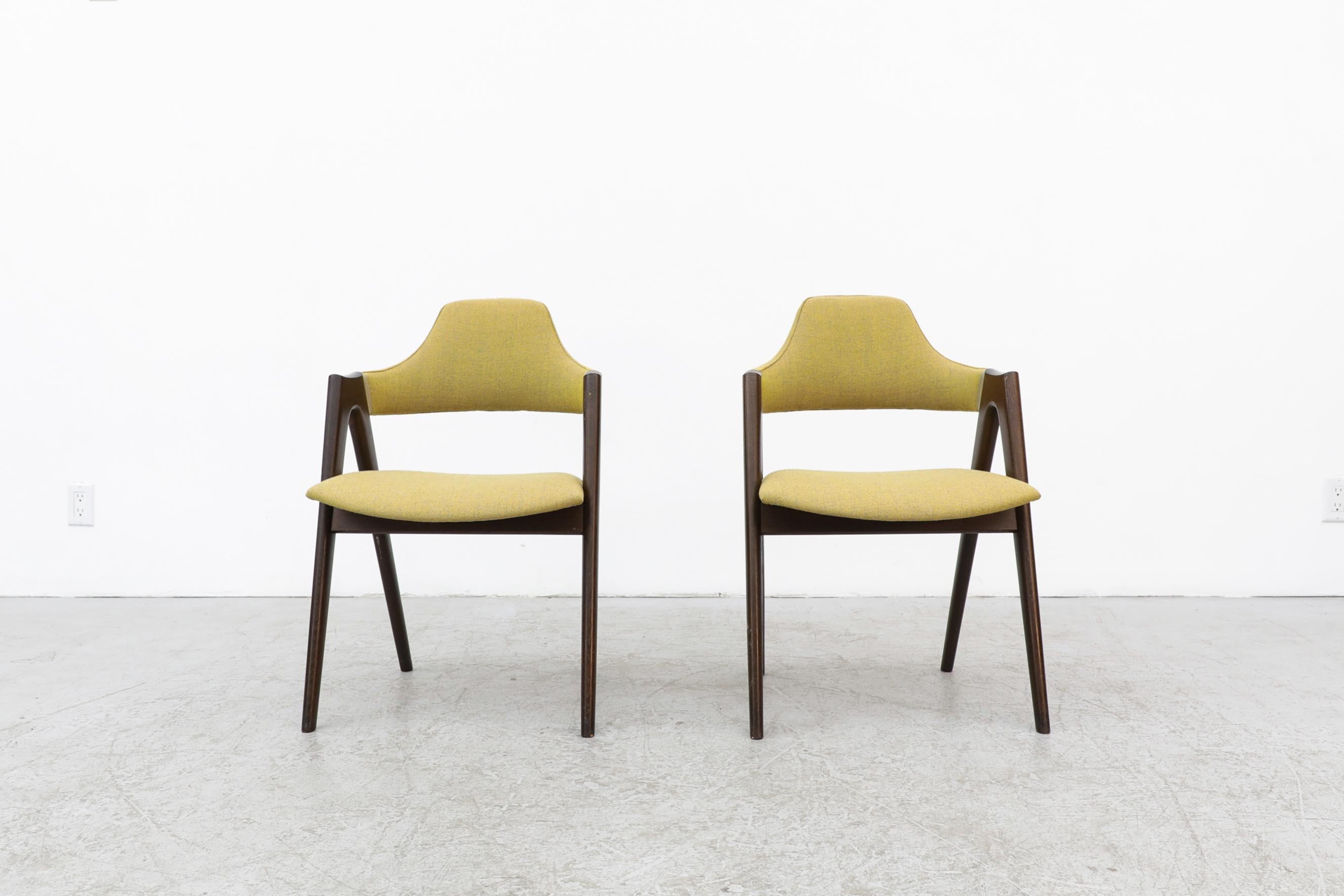 Pair of Kai Kristiansen Compass chairs with newer chartreuse upholstery. The frames are in original condition with signs of wear including some scuffs and scratching to the frame. Wear is consistent with their age and use. Other sets of Compass