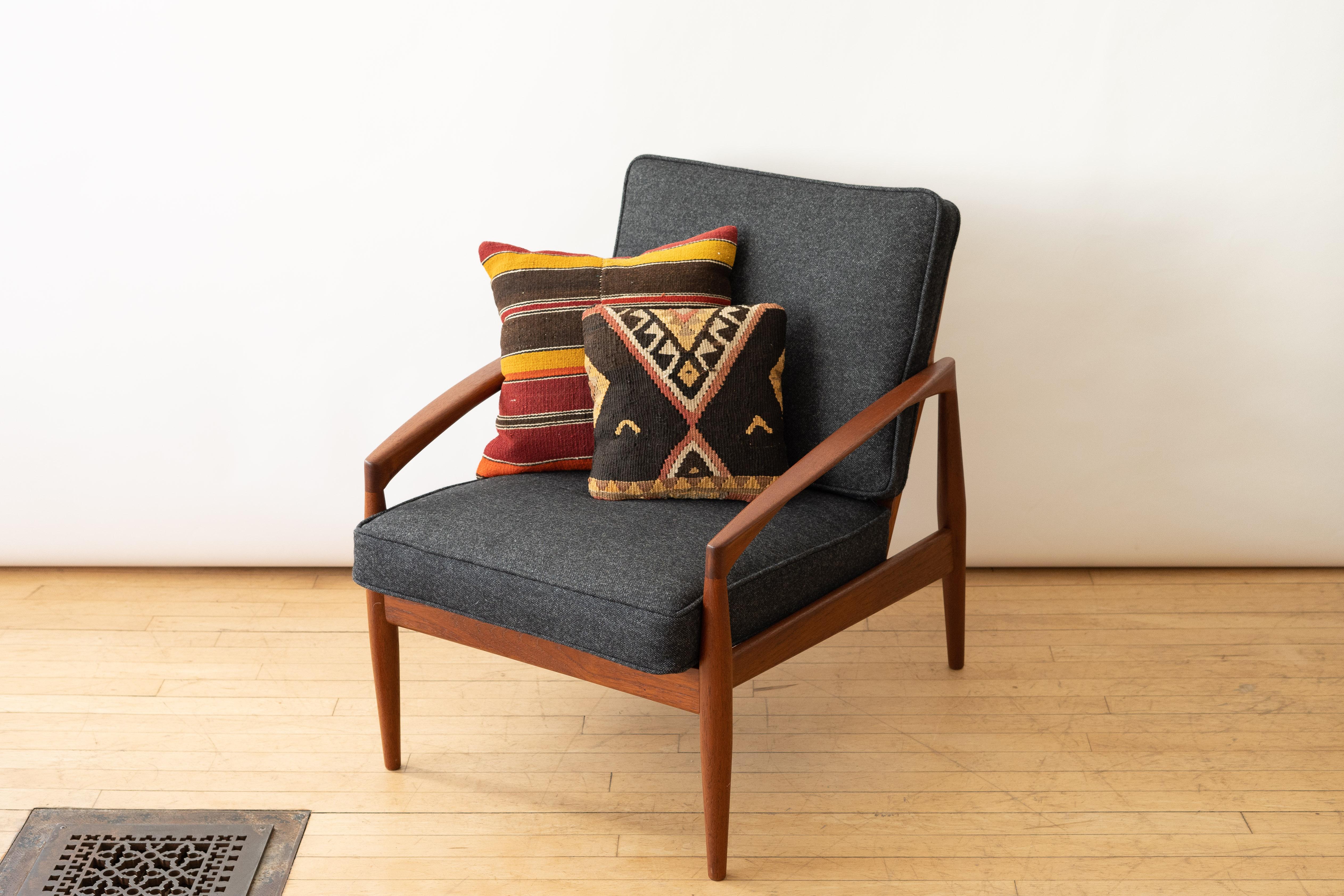 Denmark, ca. 1960s. A rare pair of Model 121 - or Paper Knife - lounge chairs designed by Kai Kristiansen for Magnus Olsen - retailed by Domus Danica. Each features a sculptural solid teak open frame with removable seat and back cushions. Referred
