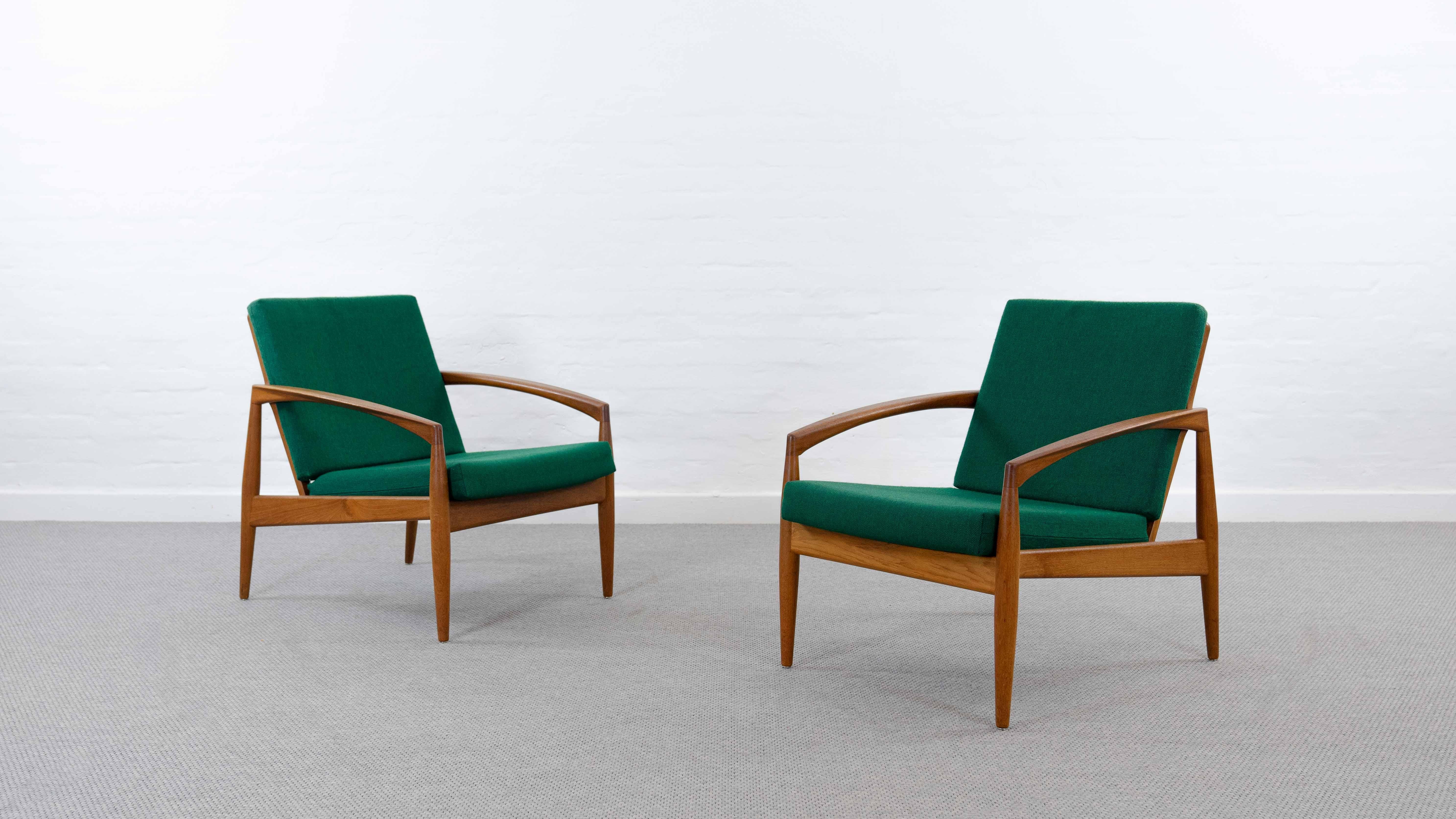 Pair of Danish armchairs, designed 1955 by Kai Kristiansen for Magnus Olesen. Model Nr. 121. So called „Paper Knive Chairs“. Executed in Teakwood with original green fabrics. Both chairs with manufacturers label.