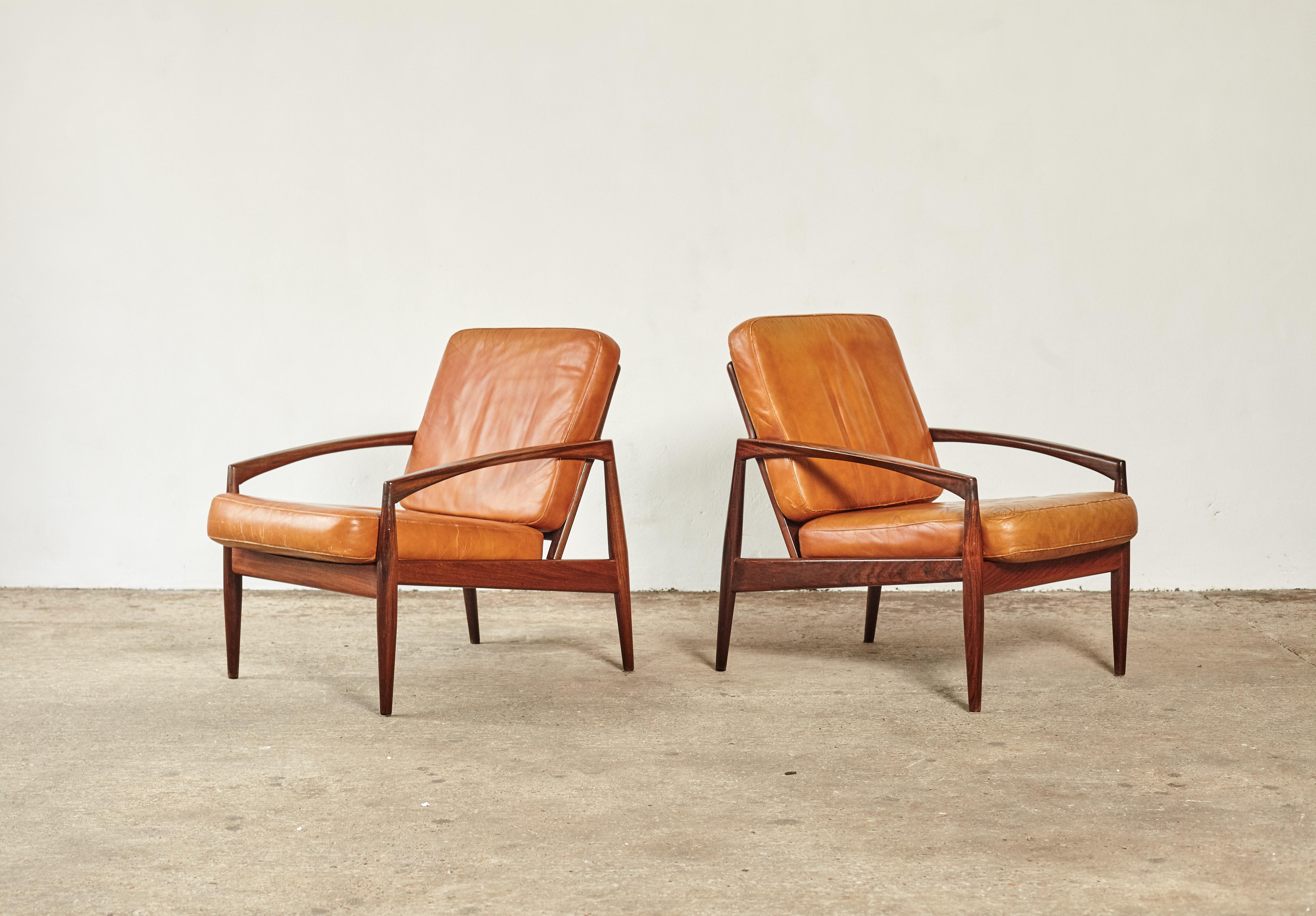 A super pair of rare rosewood Kai Kristiansen paper knife chairs, produced by Magnus Olesen, Denmark, 1960s. Rosewood frames in great condition and original patinated cognac leather cushions. The cushions are loose so easy to recover in an