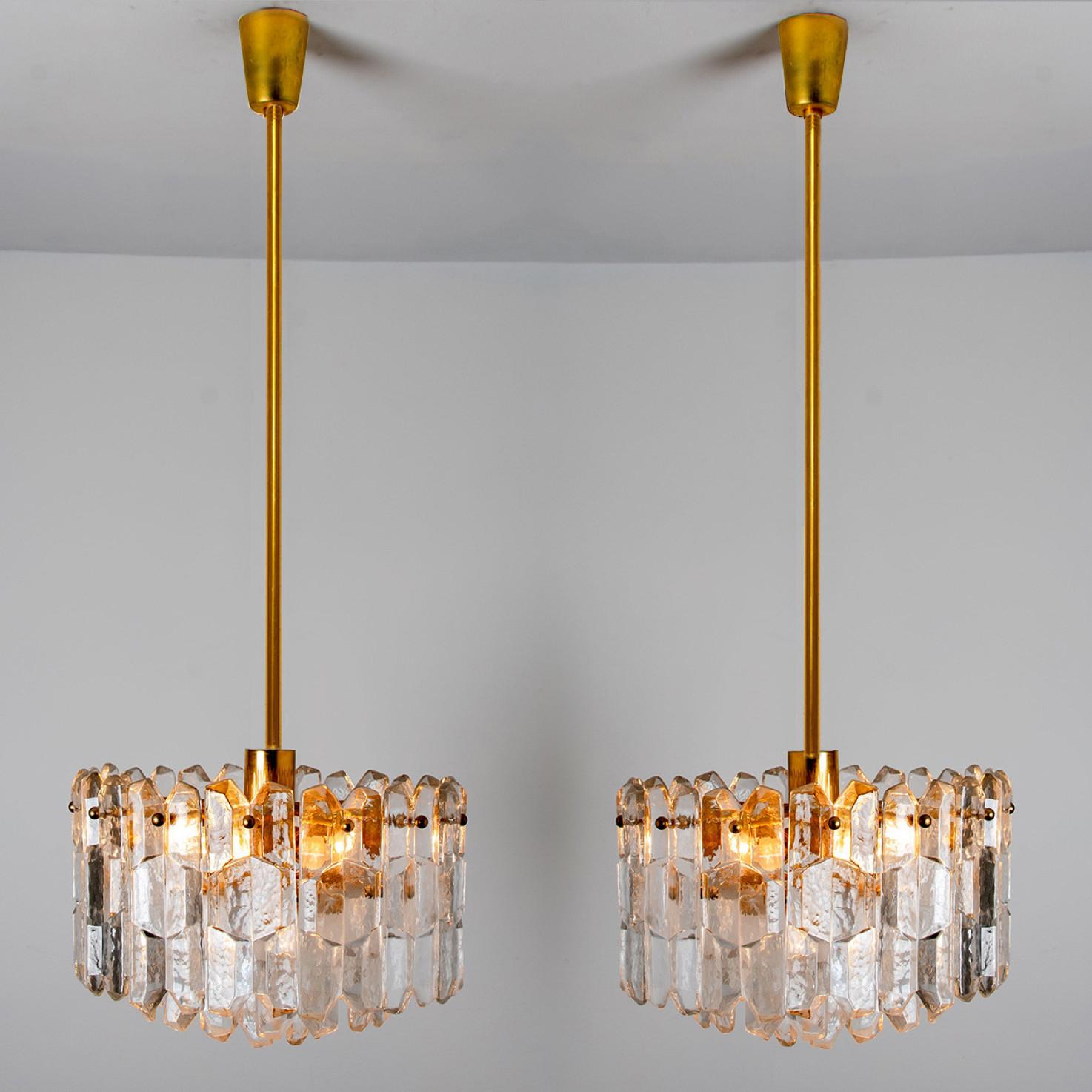 A pair of high quality and handmade gilt brass light fixtures made by Kalmar in Austria. This model Palazzo was manufactured, circa 1970-1979. Large polished brilliant crystal glasses are mounted on a gilded brass frame.

It needs seven small